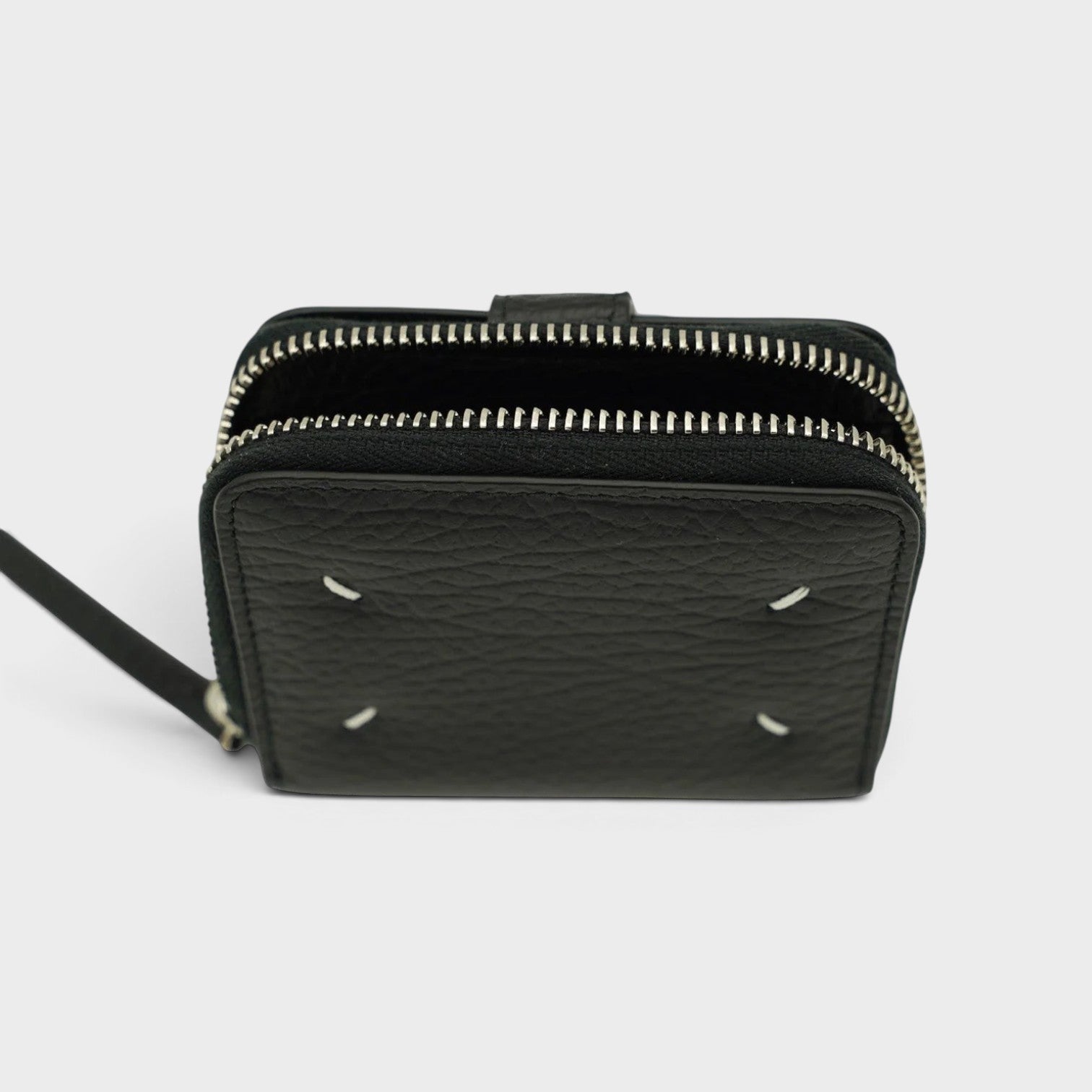 Supplied Fashion Maison Margiela black leather coin pouch with signature white four-stitch detail and silver zipper.