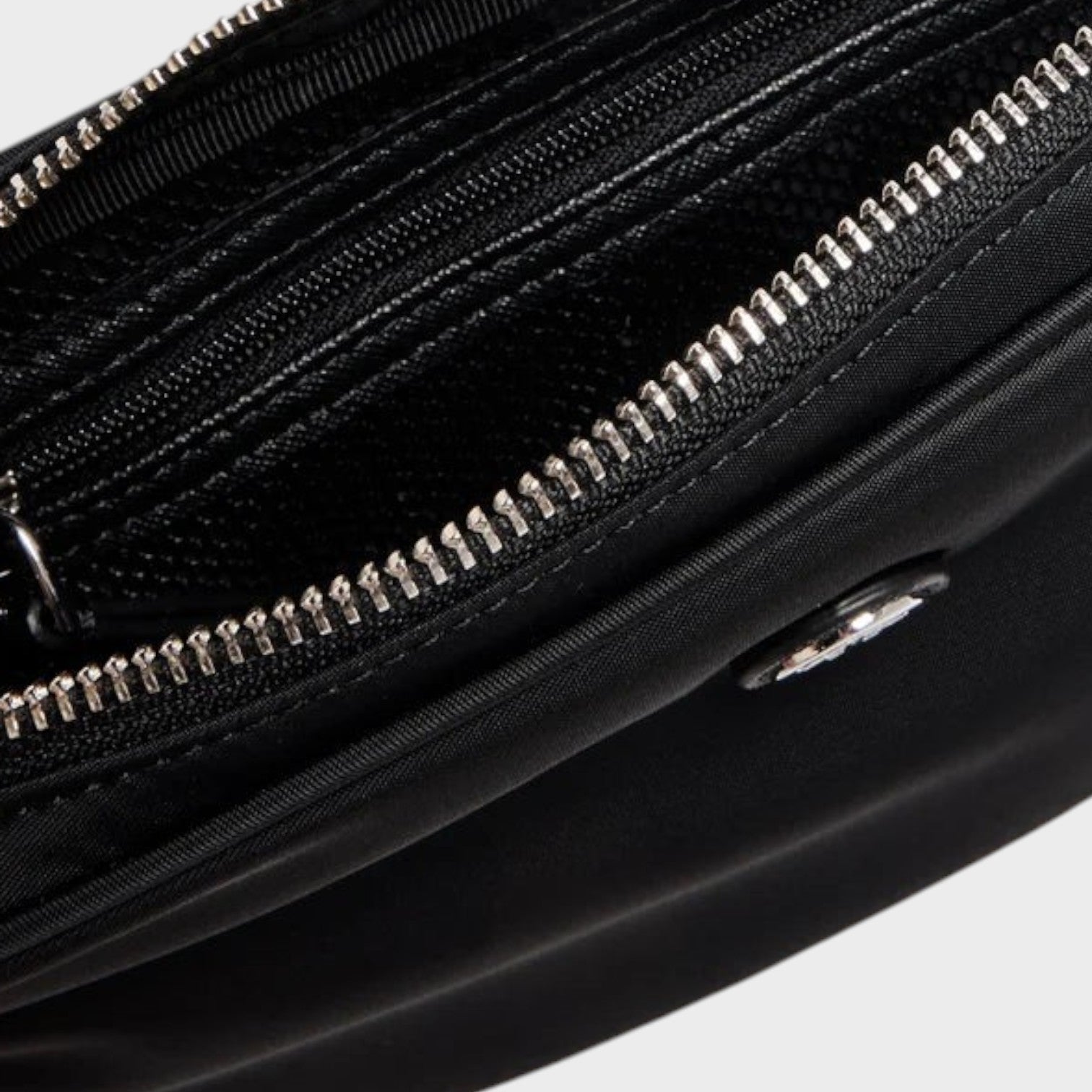 Supplied Fashion Virginia black nylon belt bag featuring a silver zippered main compartment and adjustable strap.