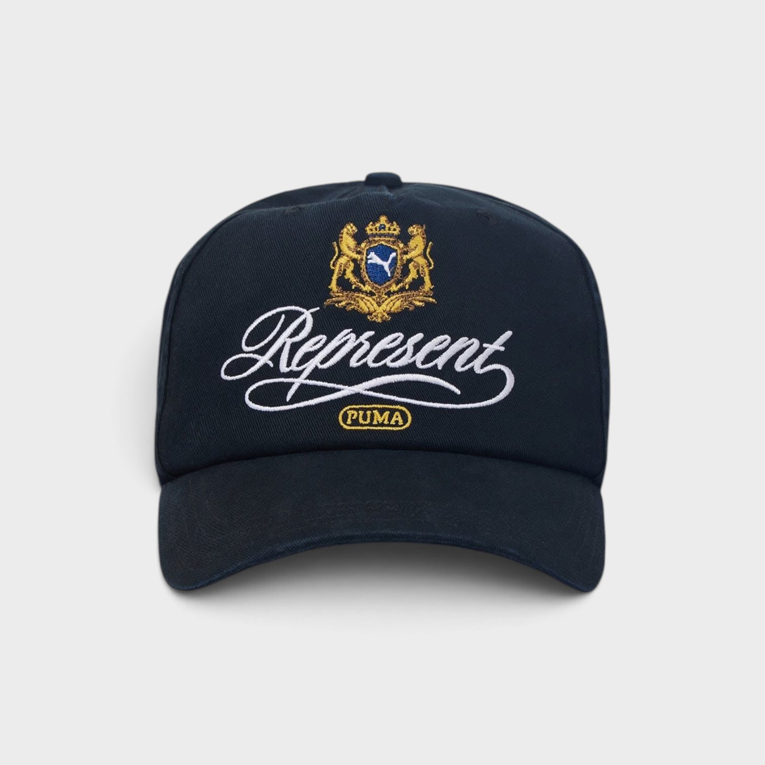 Supplied Fashion black baseball cap with an embroidered gold and white Puma crest logo on the front
