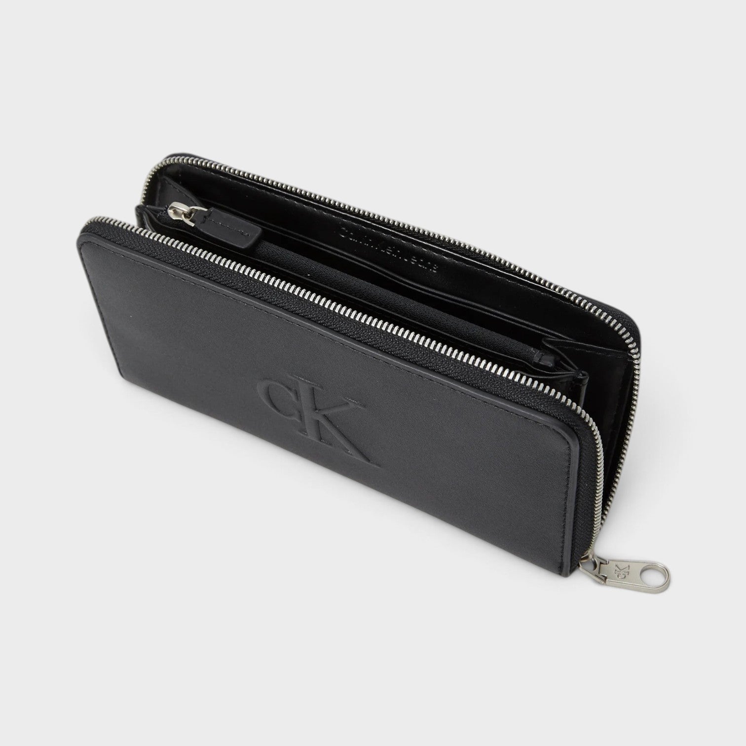 Supplied Fashion black Calvin Klein zip-around wallet with sculpted logo and silver hardware