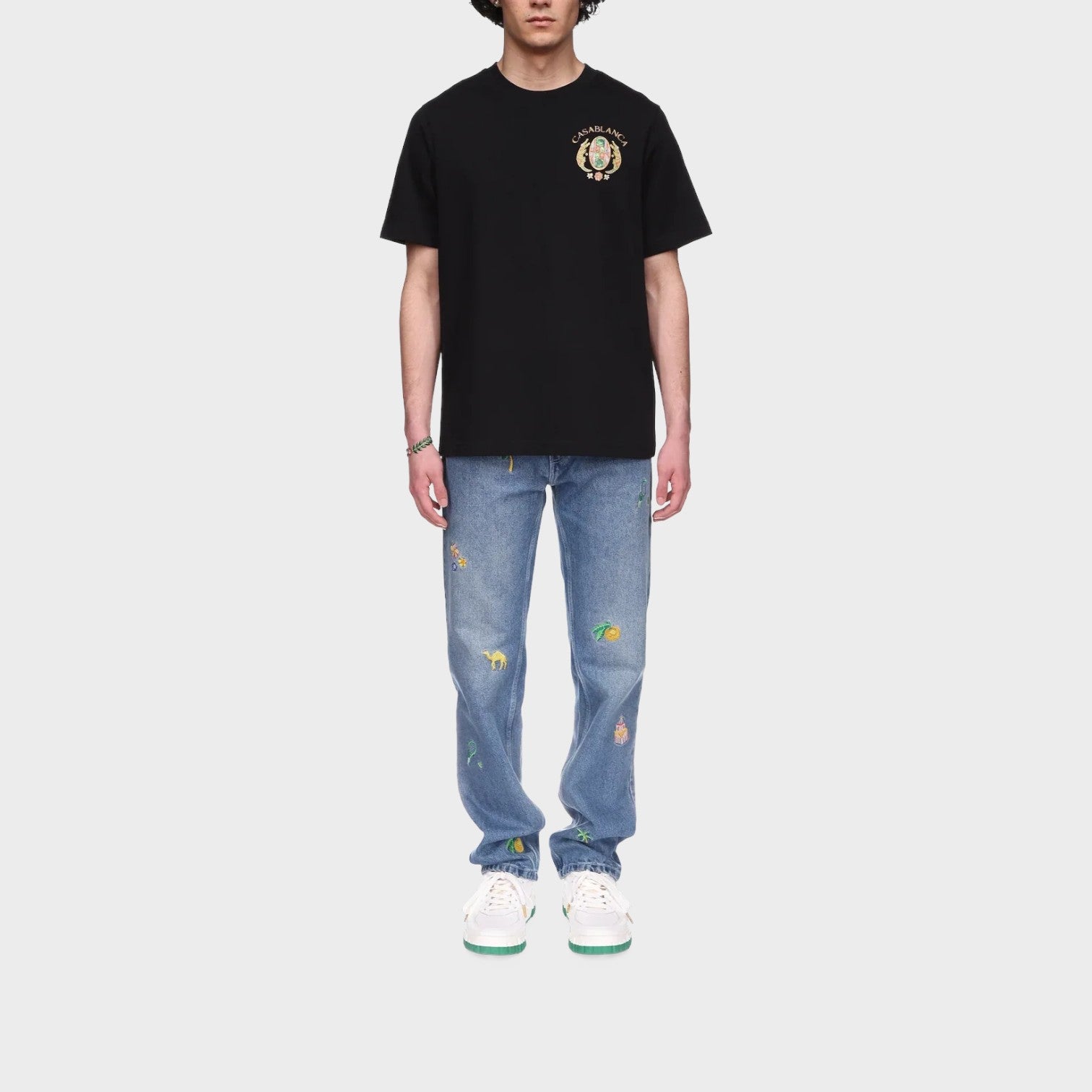 Supplied Fashion black short sleeve t-shirt with Tennis Club graphic on chest worn by a model with blue jeans