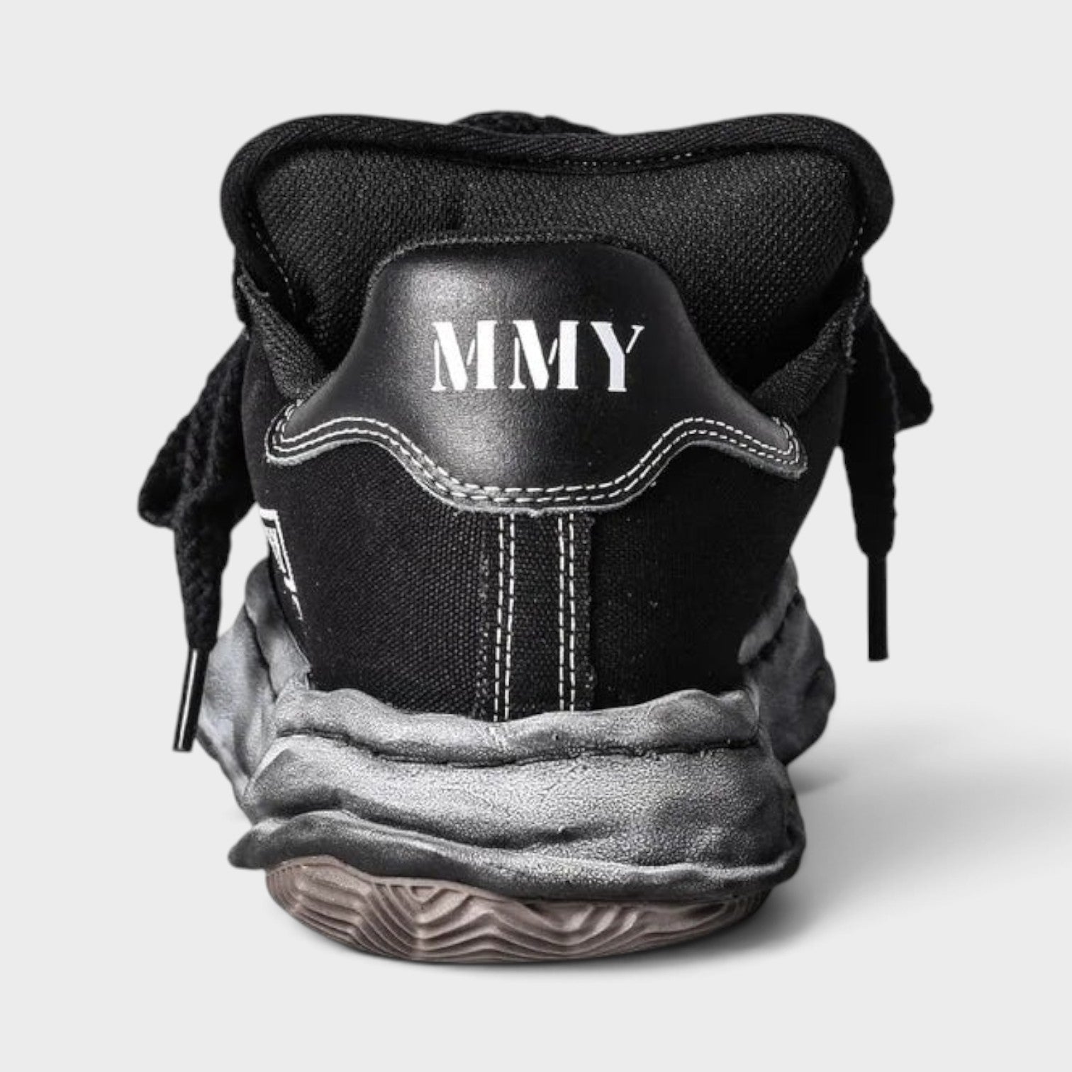 Supplied Fashion Yasuhiro Blakey Puffer black canvas sneaker showing the rear view with MMY logo and distressed sole