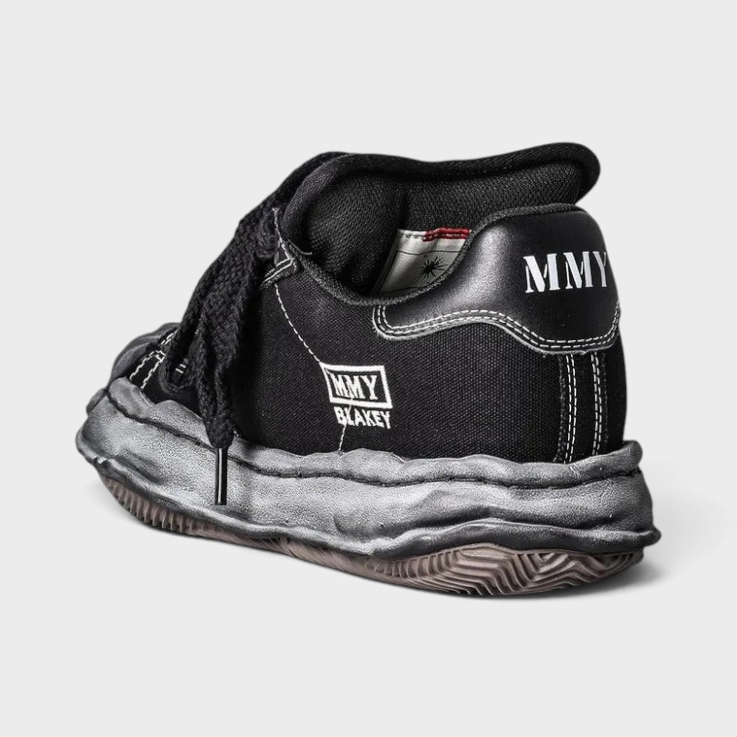 Supplied Fashion Yasuhiro Blakey black canvas low-top sneaker with signature distressed OG sole and MMY heel branding.