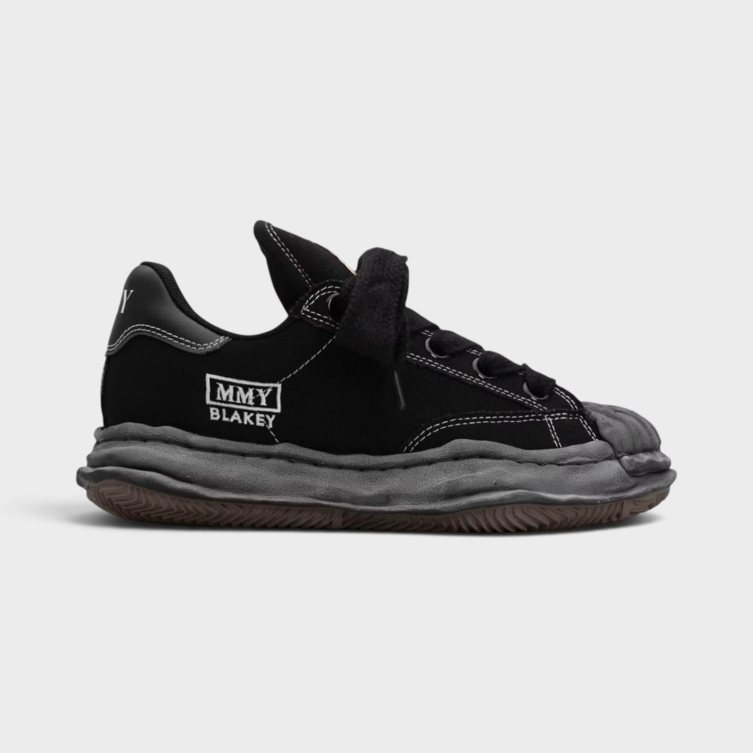 Supplied Fashion Maison Mihara Yasuhiro Blakey Puffer black canvas low-top sneaker with signature distressed OG sole.