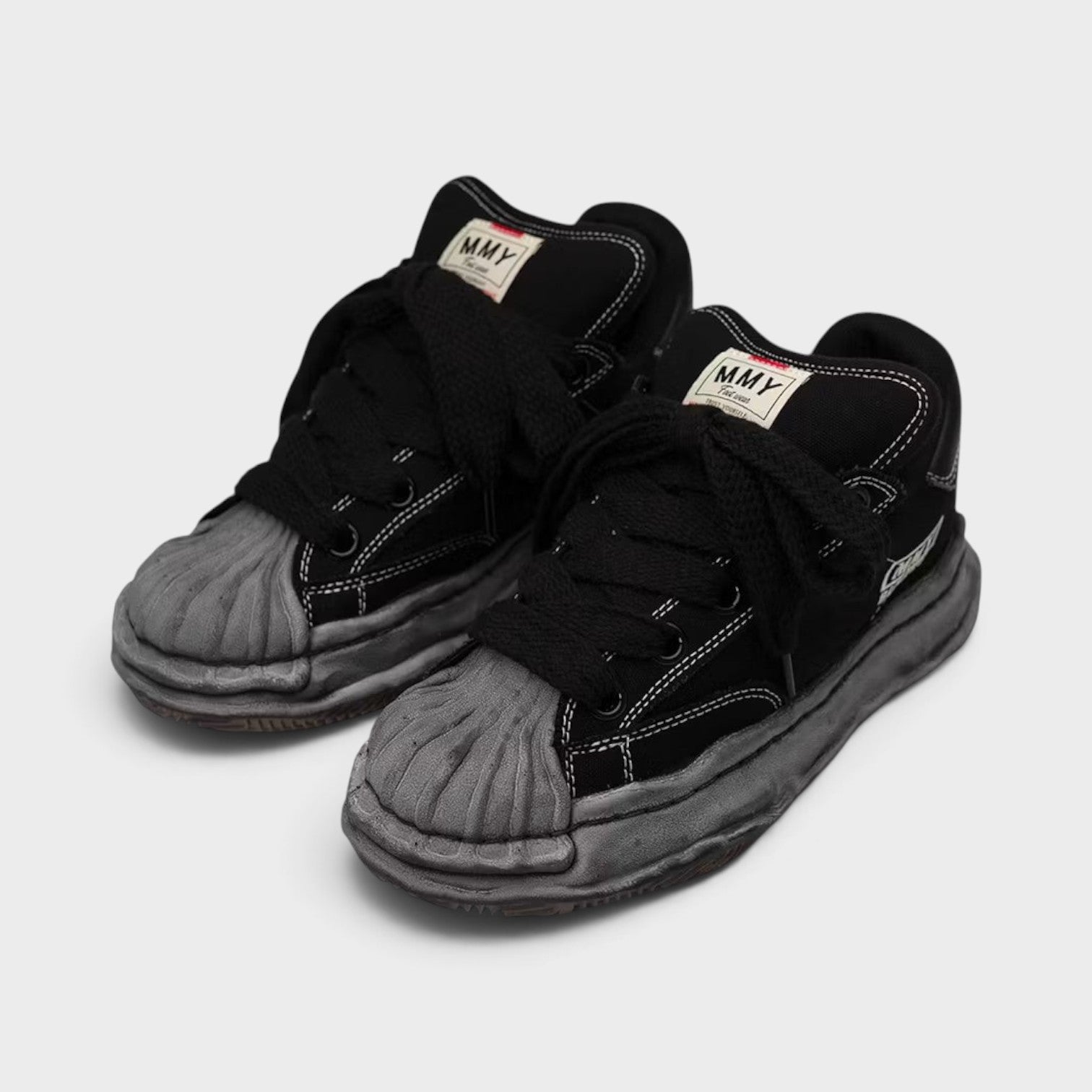 Supplied Fashion Maison Mihara Yasuhiro Blakey Puffer black canvas low-top sneakers with signature distressed OG sole