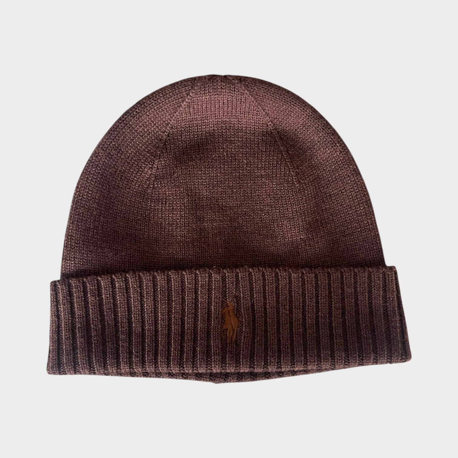 Supplied Fashion brown knit beanie with a ribbed cuff and an embroidered pony logo on the front.