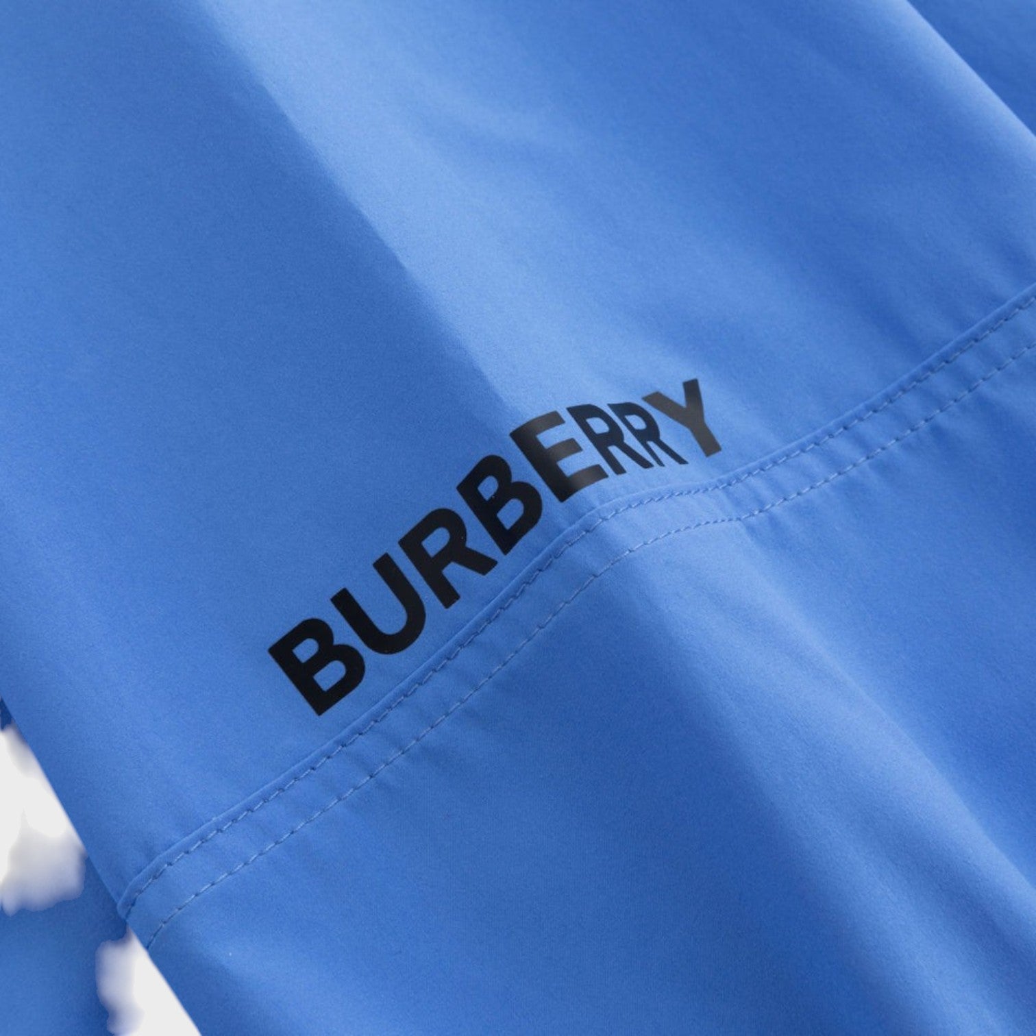 Supplied Fashion Burberry Birley long blue jacket featuring a bold black logo print on smooth fabric