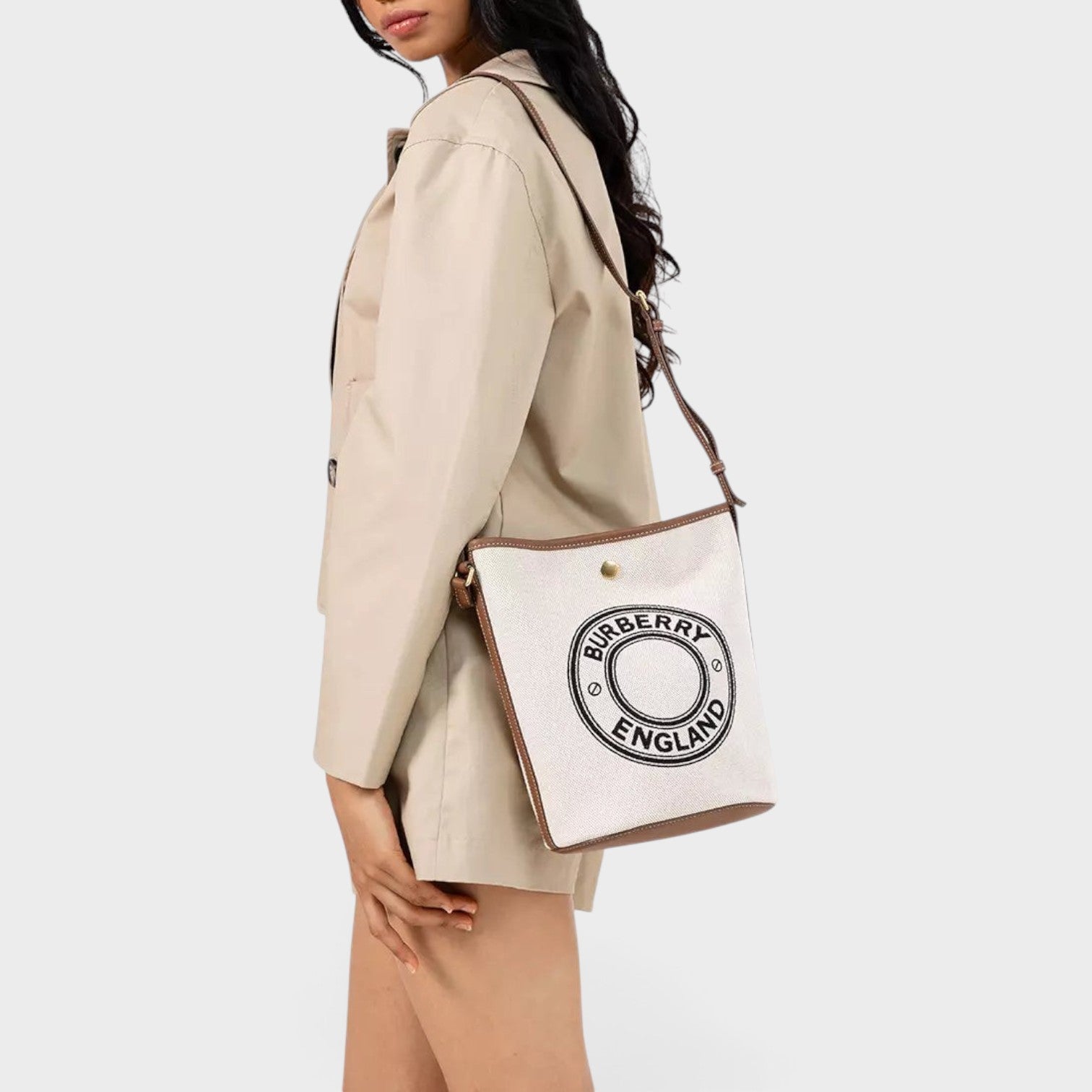 Supplied Fashion Burberry Roundel medium bucket bag in dark wheat beige canvas with brown leather trim on a model