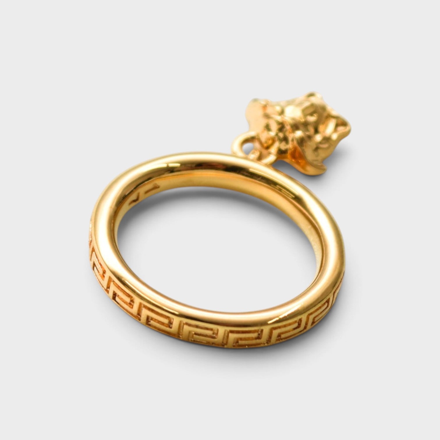 Supplied Fashion gold ring featuring an engraved Greca pattern and a dangling Medusa head charm