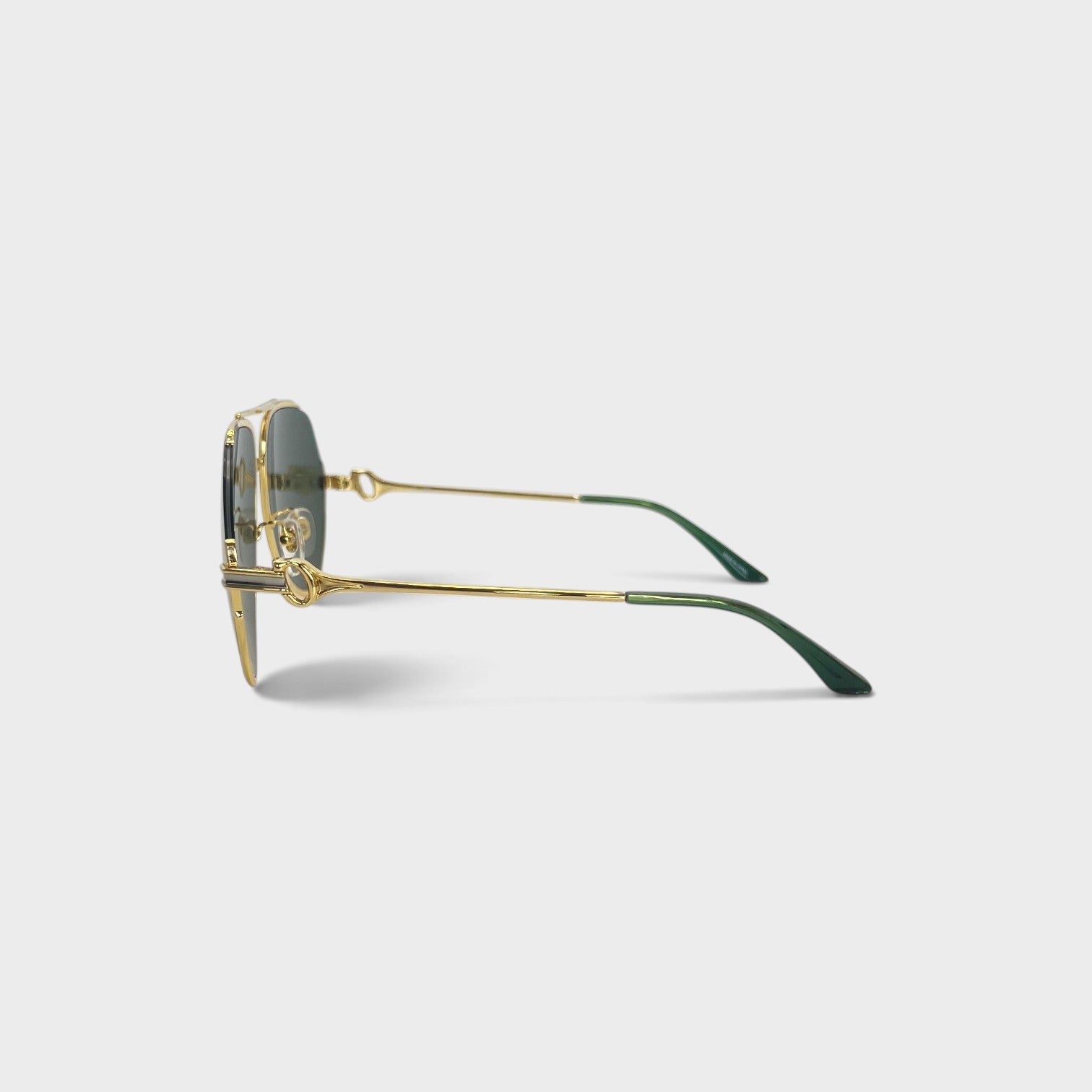 Supplied Fashion rounded stainless steel sunglasses with green lenses and gold frames, side profile view.
