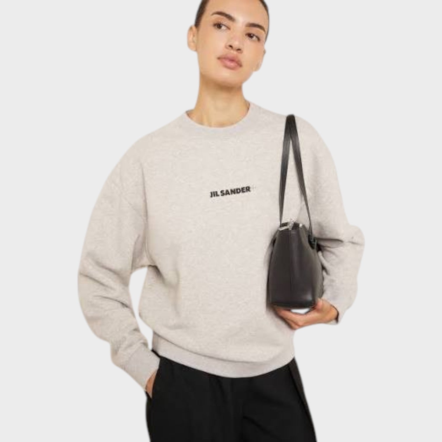 Supplied Fashion grey Jil Sander logo terry sweatshirt worn by a model with a black handbag