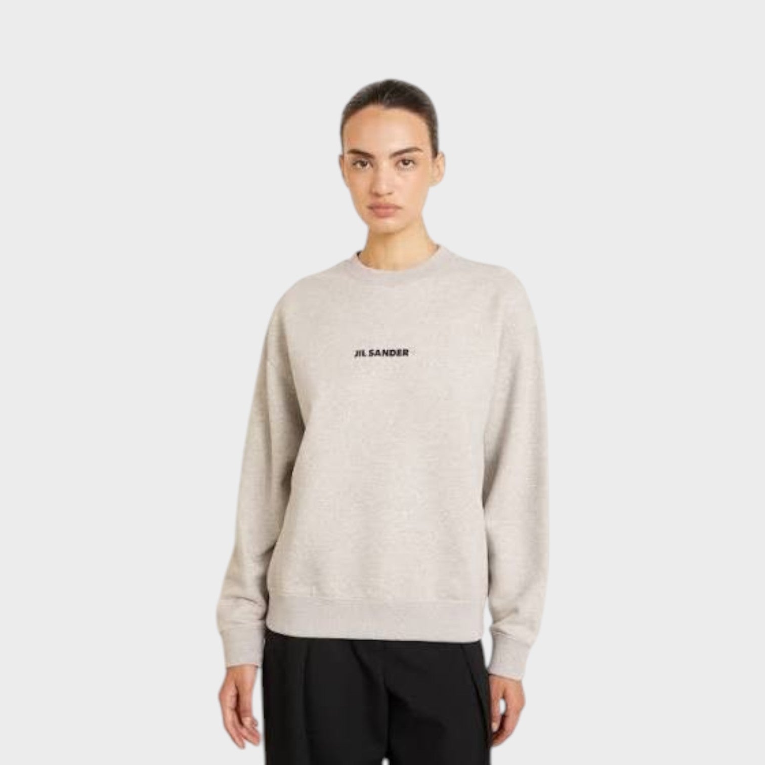 Supplied Fashion grey terry sweatshirt with black Jil Sander logo, worn by a model in a relaxed fit.