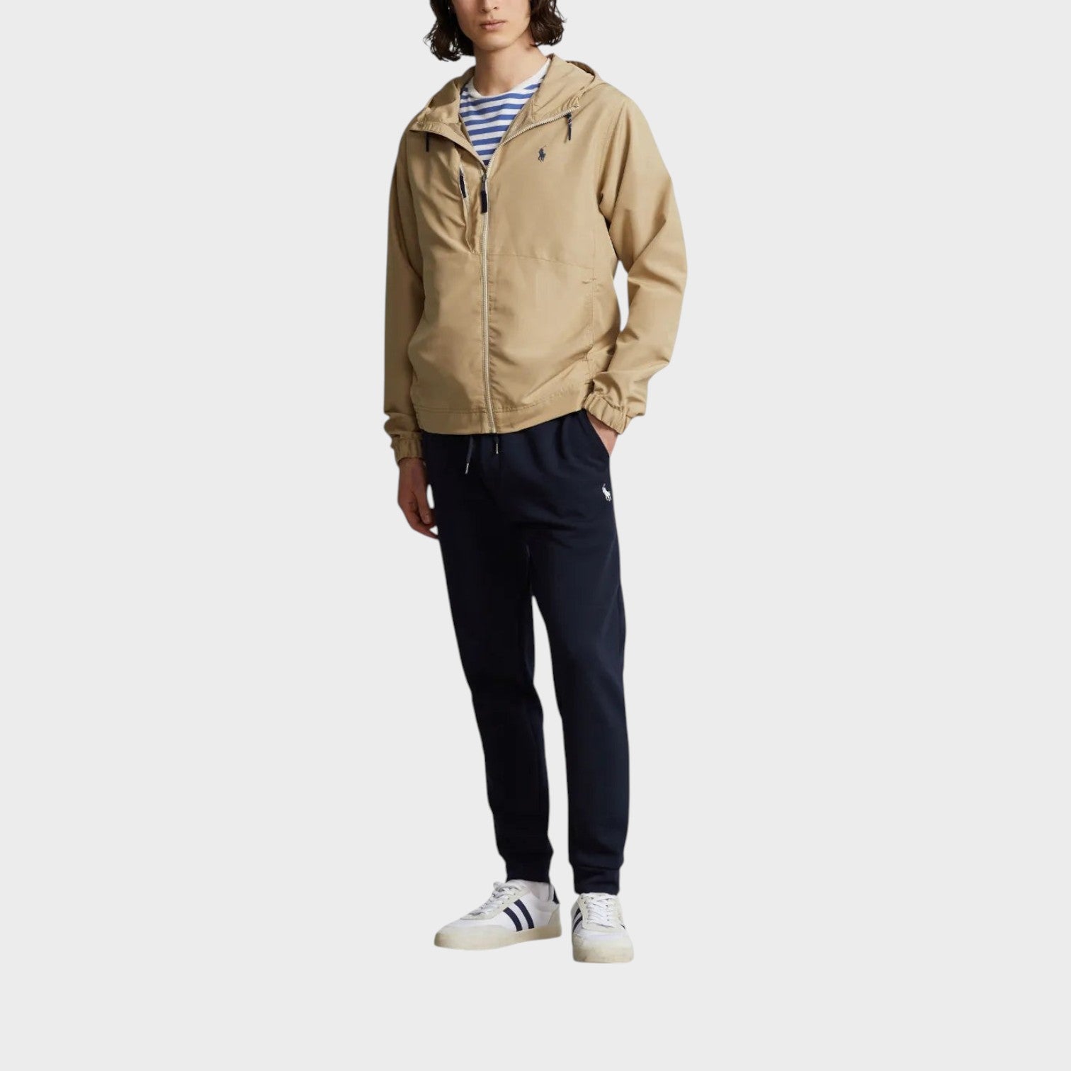 Supplied Fashion khaki hooded jacket with front zip, drawstring hood, and embroidered chest logo on a male model.