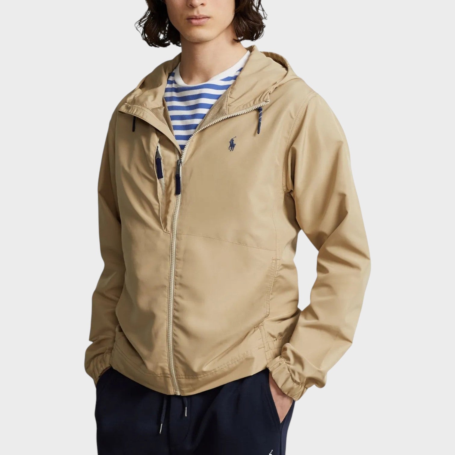 Supplied Fashion khaki hooded jacket with front zip, embroidered logo, and elasticated cuffs worn by a model.