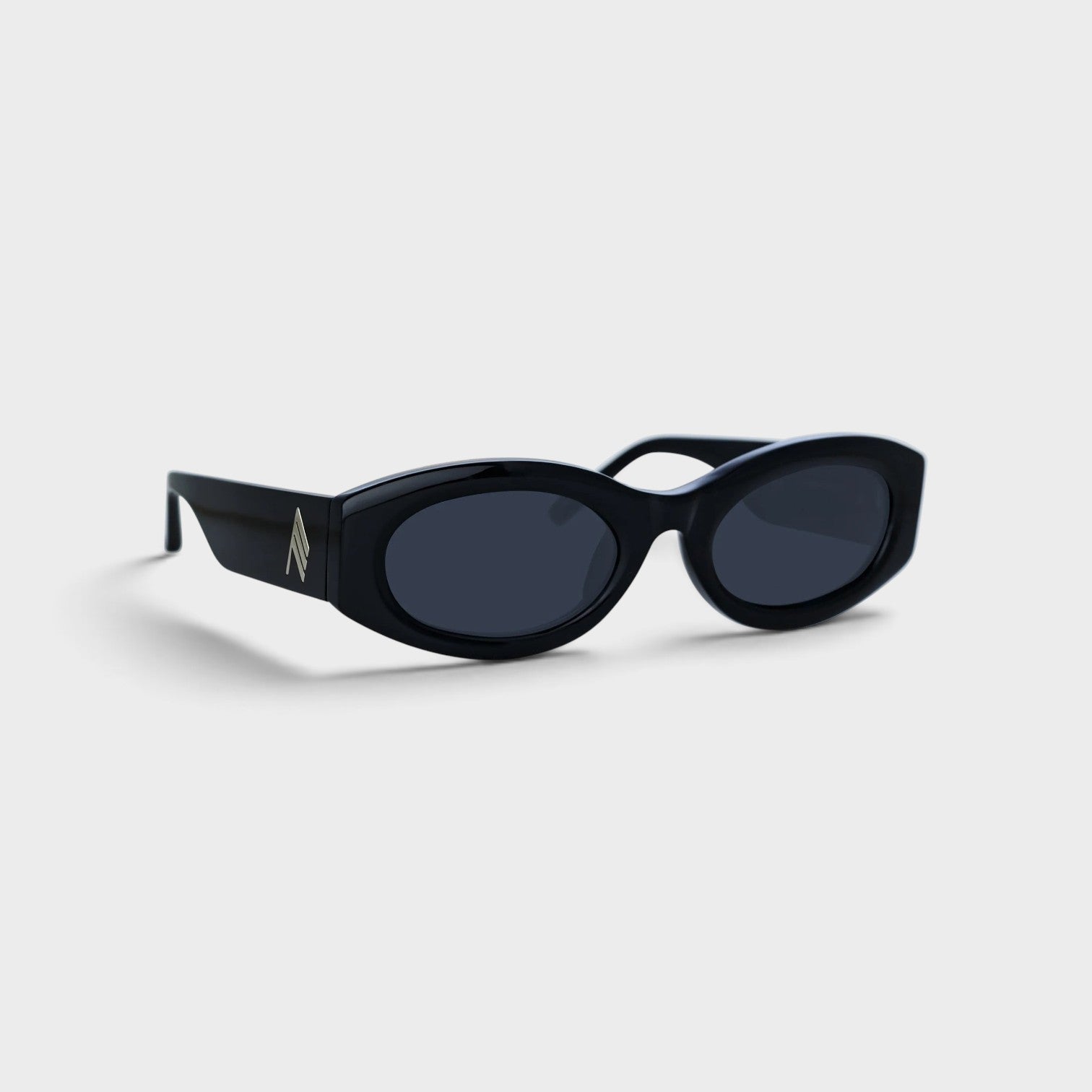 Supplied Fashion Linda Farrow Berta black oval sunglasses with sleek frames and metallic logo detail on the temple.