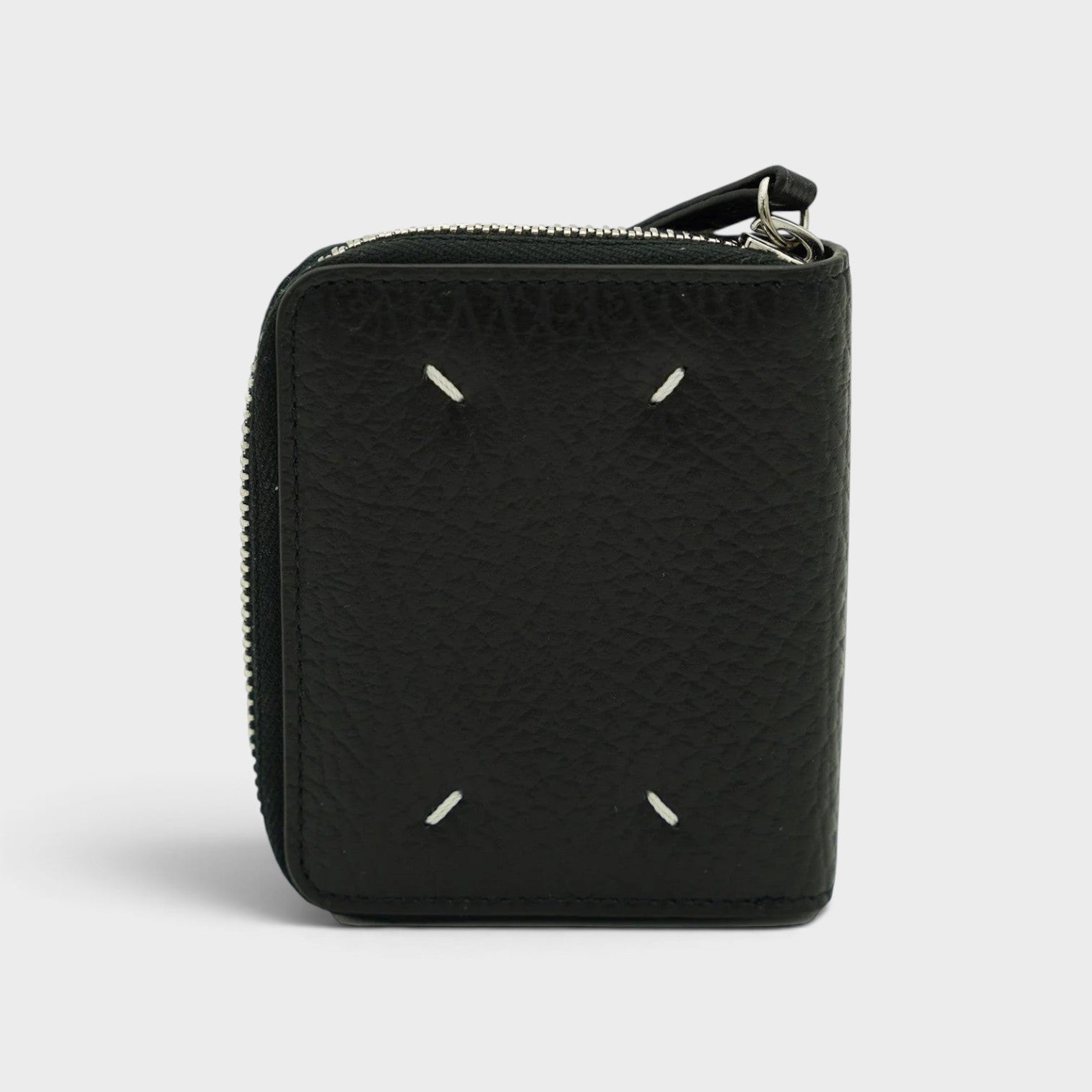 Supplied Fashion Maison Margiela black leather coin pouch with signature white four-stitch detailing and zip closure.
