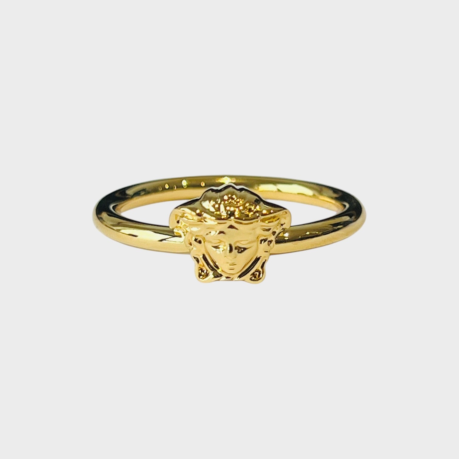 Supplied Fashion gold tone metal ring with a detailed Medusa head design. Edgy, artistic jewellery with historical flair.