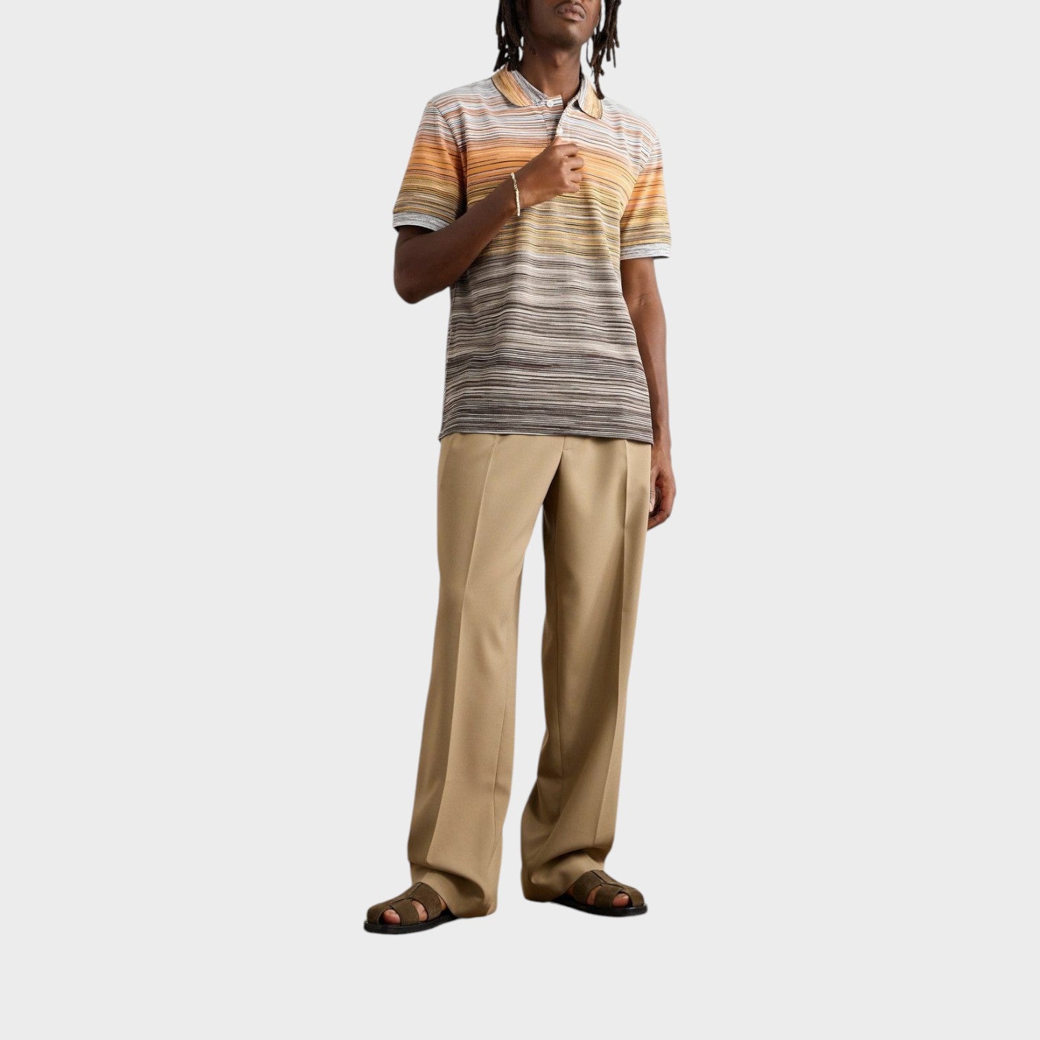 Supplied Fashion Missoni space-dyed cotton piqué polo shirt in multi-coloured stripes worn by a model with tan trousers