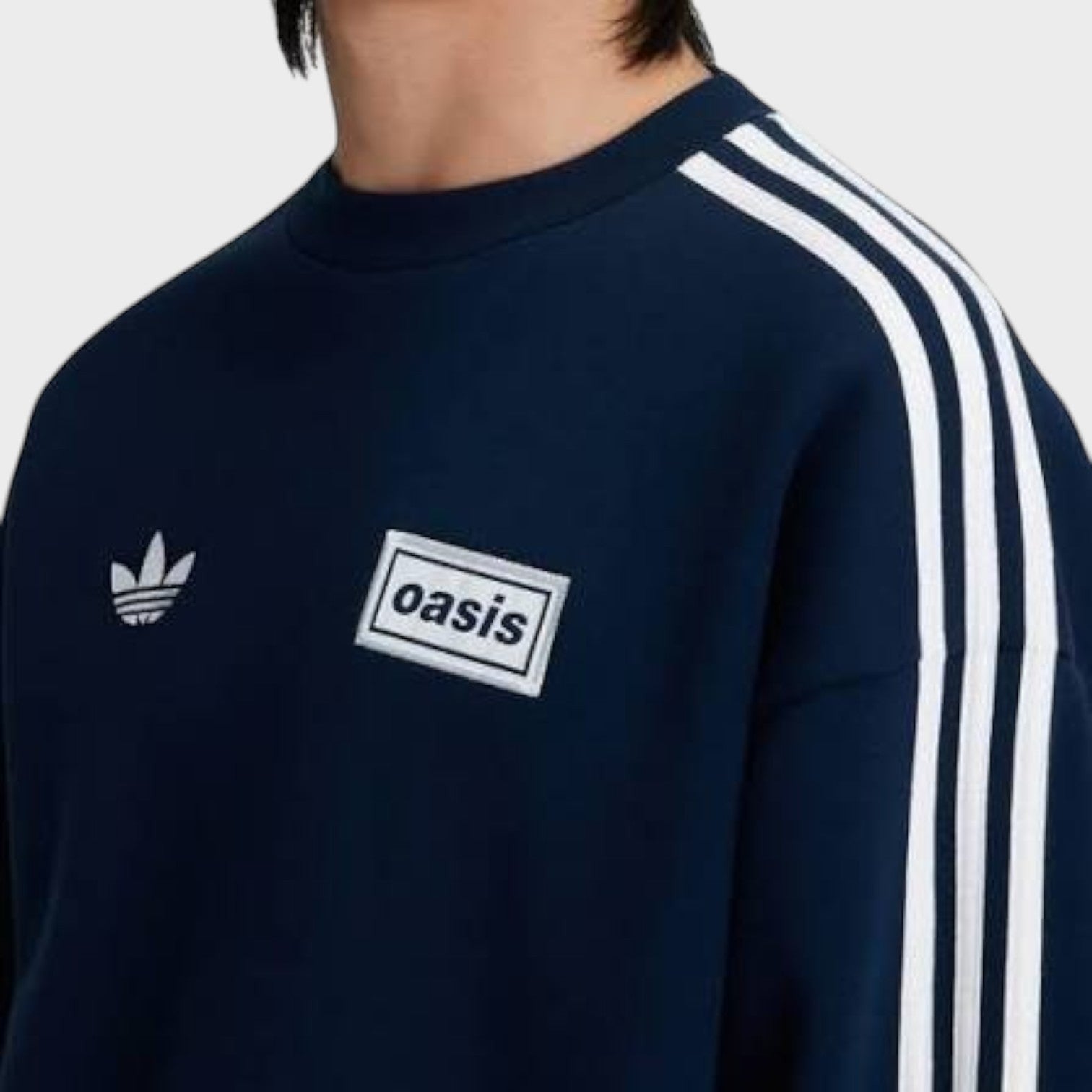 Supplied Fashion navy blue oversized adidas crewneck sweatshirt with white Oasis tour patch and three-stripe sleeves