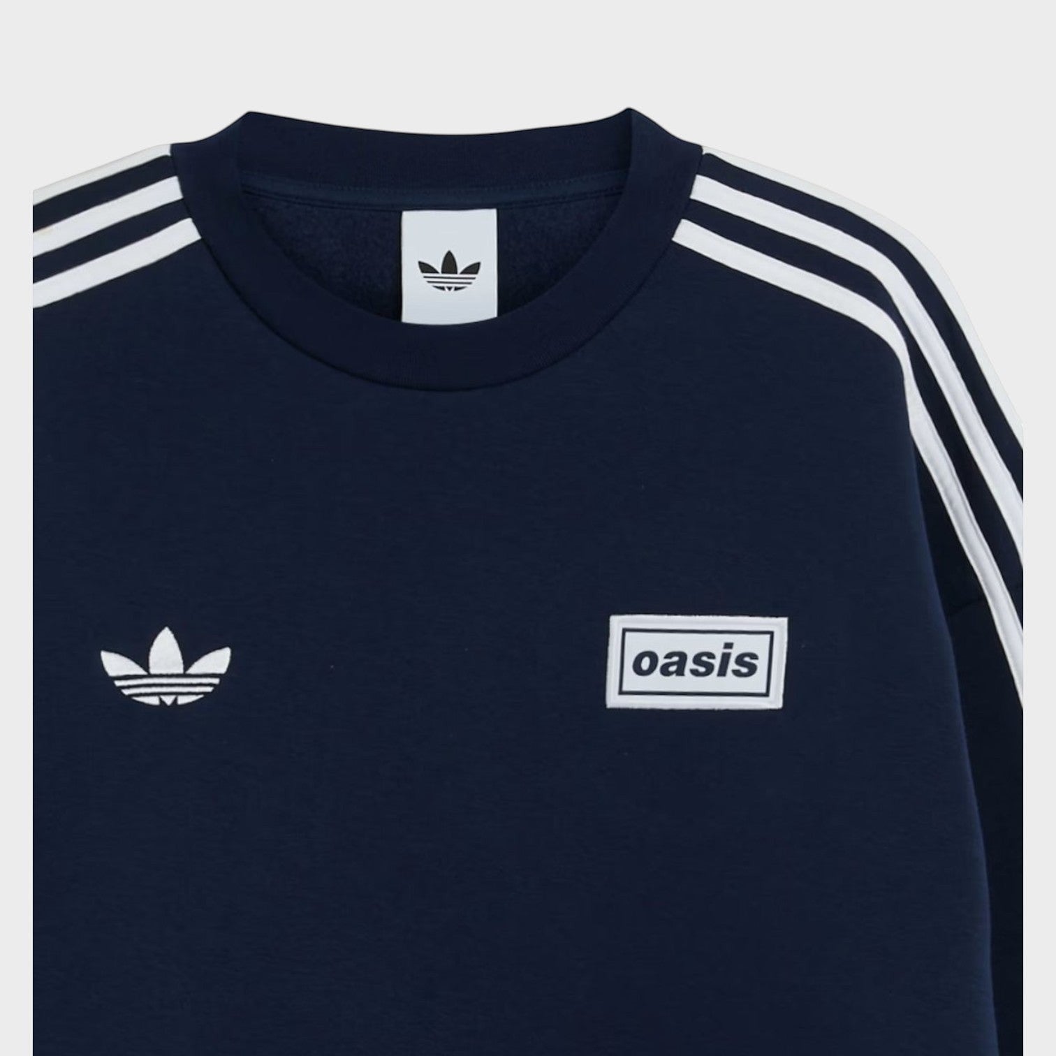 Supplied Fashion navy blue oversized crewneck sweatshirt featuring white adidas trefoil logo and Oasis tour graphic.