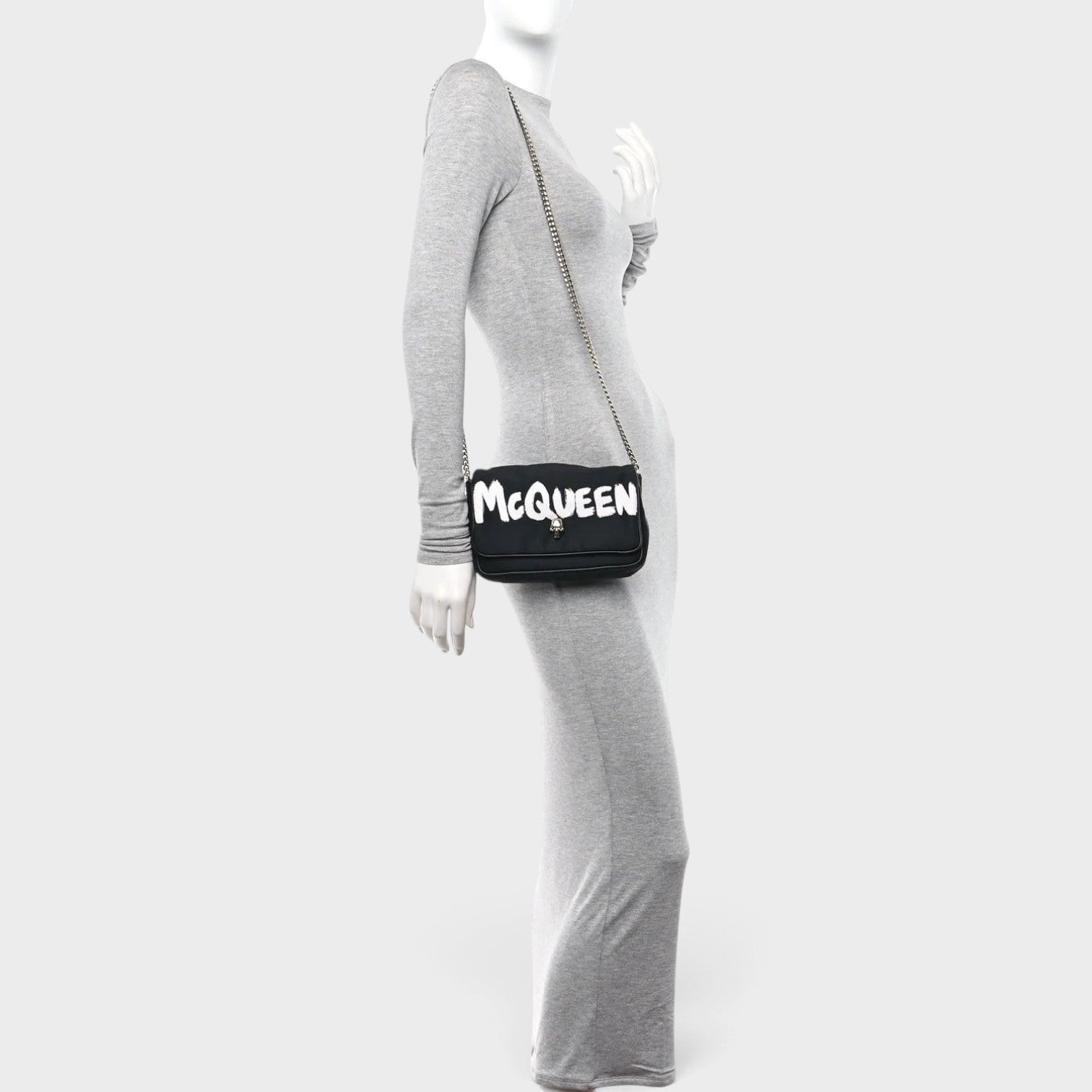 Supplied Fashion black nylon crossbody bag with white graffiti skull logo on a mannequin