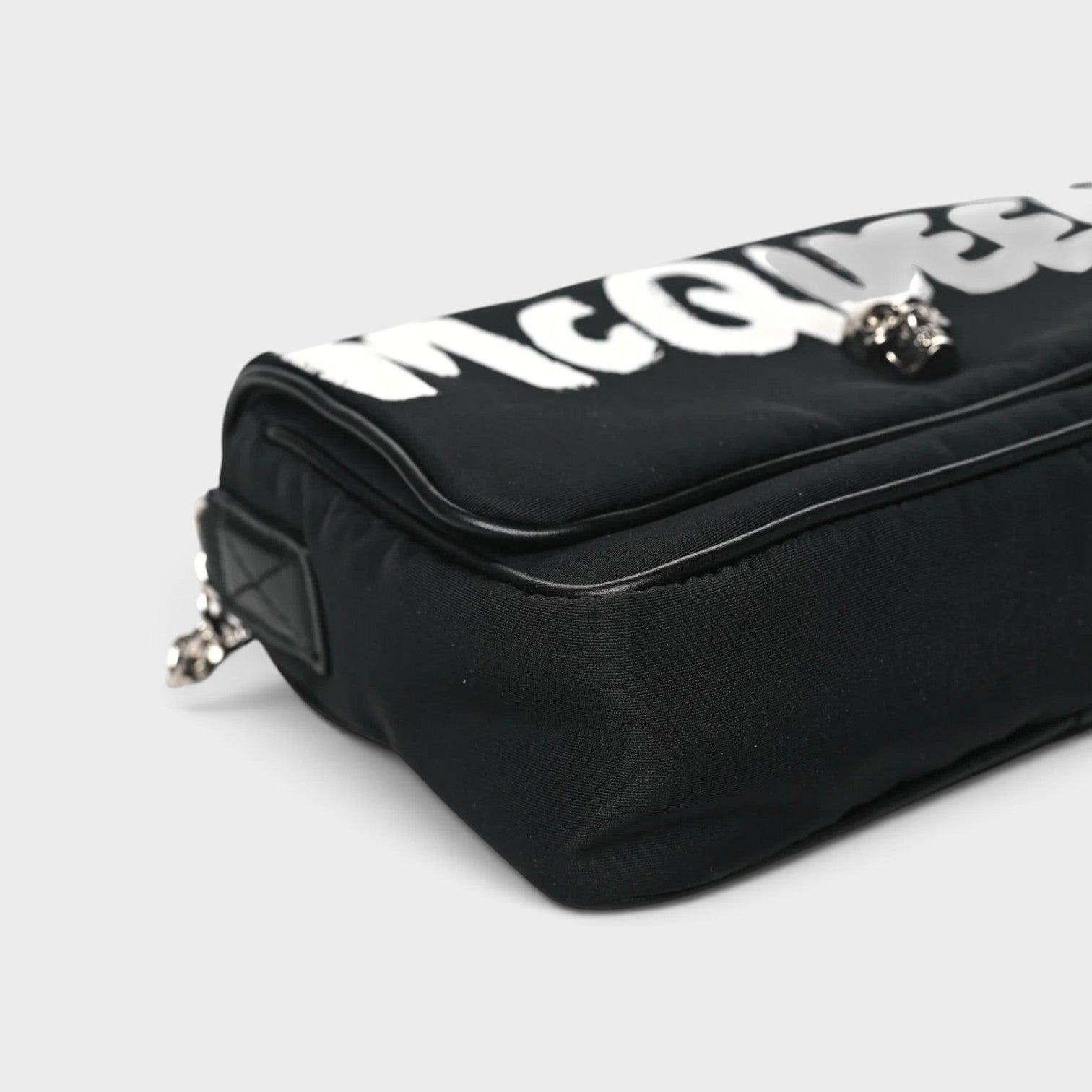 Supplied Fashion black nylon crossbody bag with white graffiti skull motif and adjustable shoulder strap