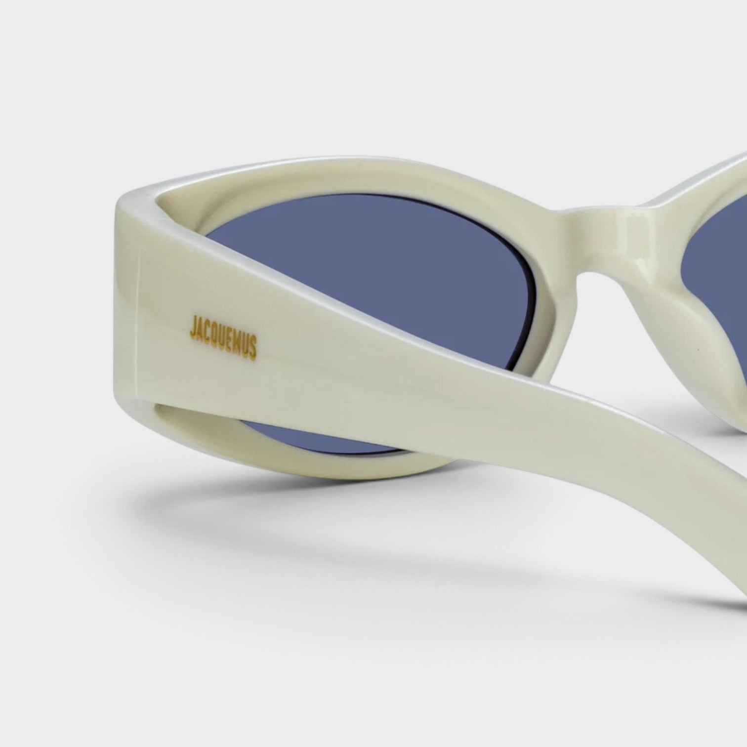 Supplied Fashion Linda Farrow Ovalo oval sunglasses in white with blue lenses and gold Jacquemus logo detail