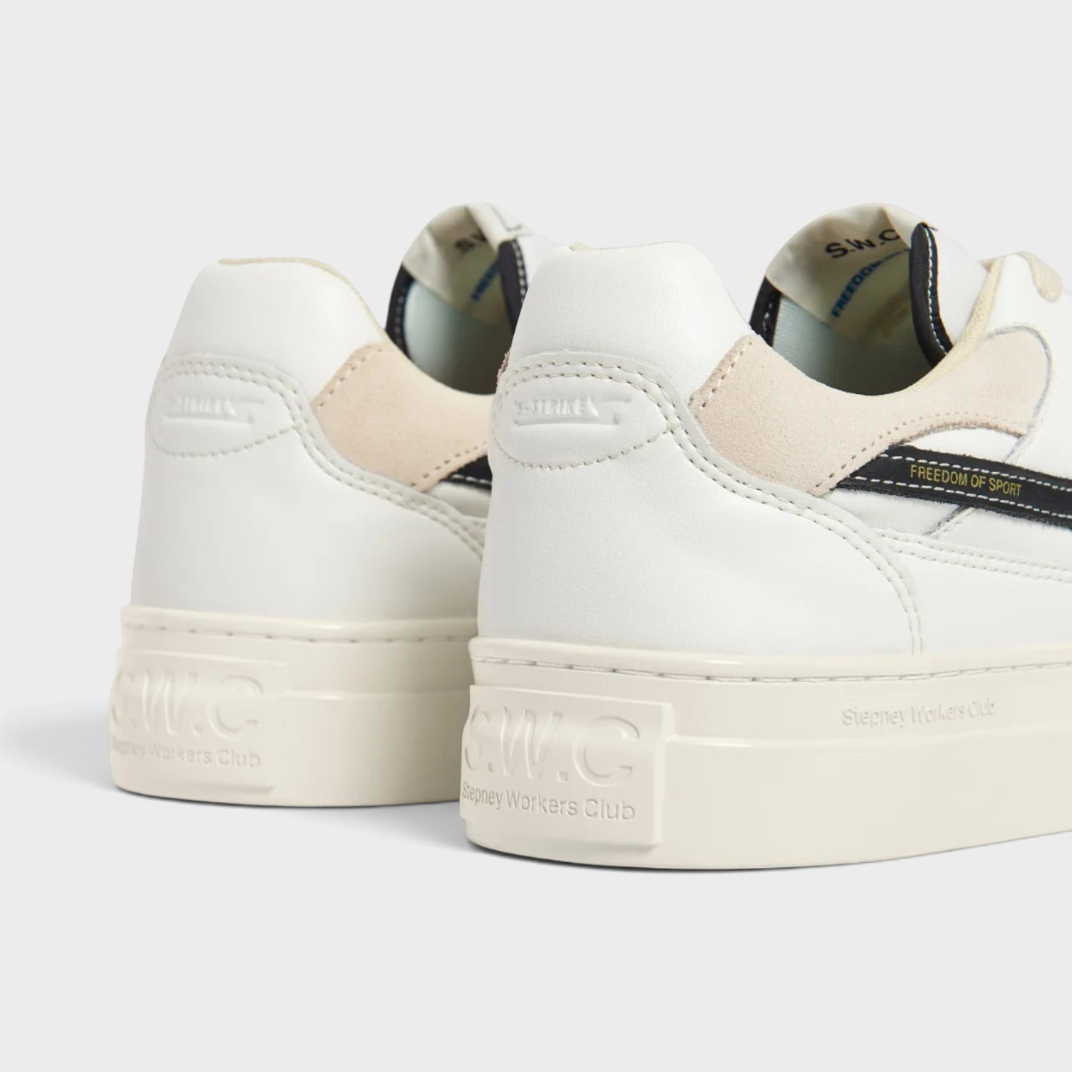 Supplied Fashion Pearl S-Strike white leather sneakers with black detailing and cream rubber soles, rear view.