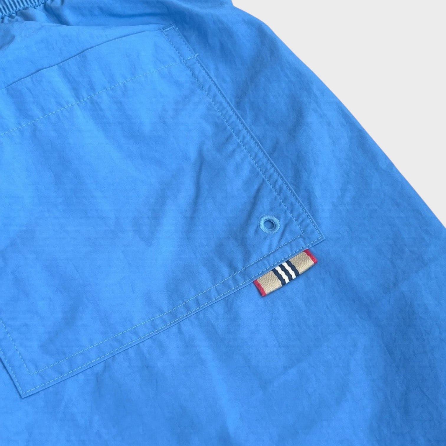 Supplied Fashion Martin nylon swim shorts in periwinkle blue featuring a back pocket with a signature logo tab.