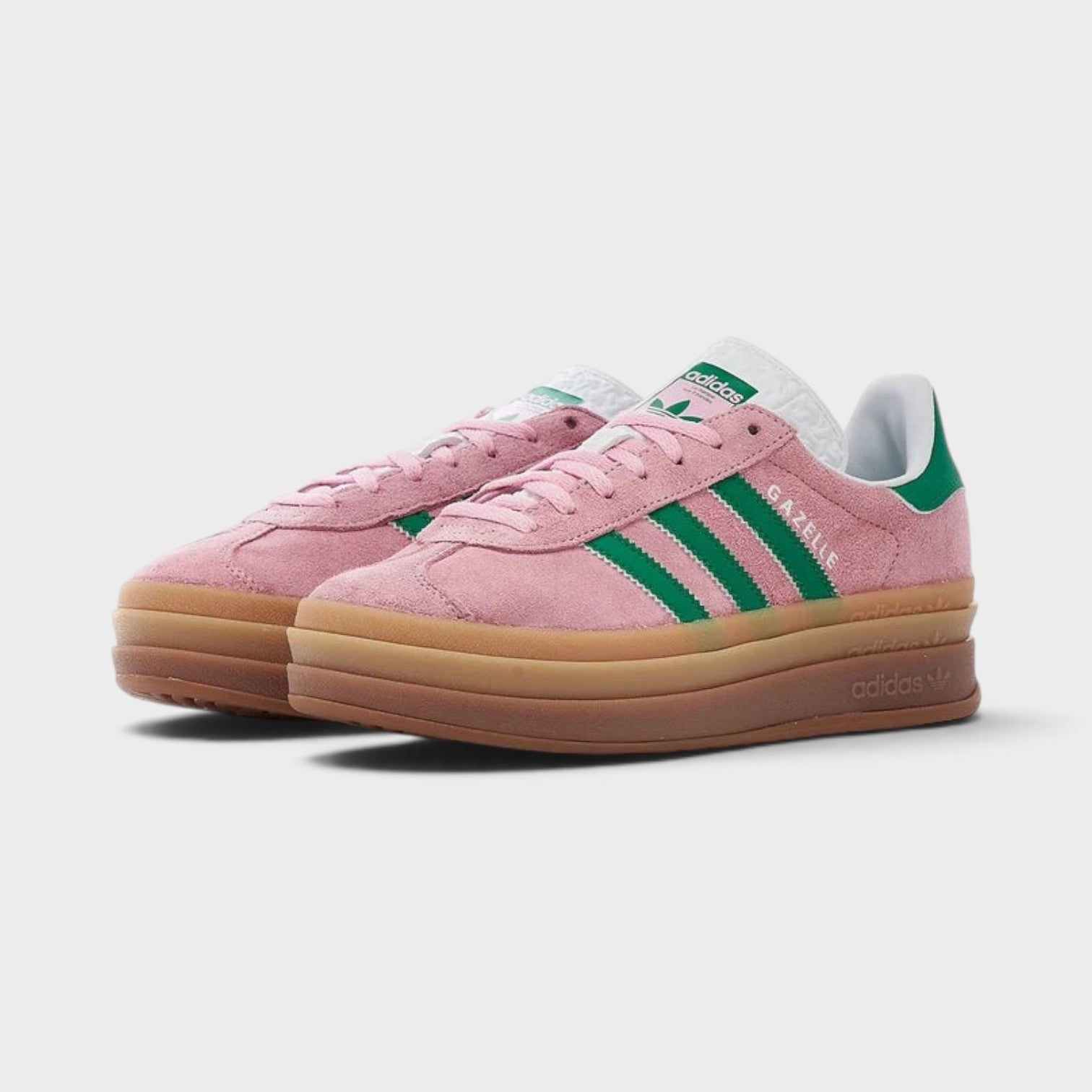 Supplied Fashion adidas Originals Gazelle Bold sneakers in true pink suede with green stripes and platform gum sole.