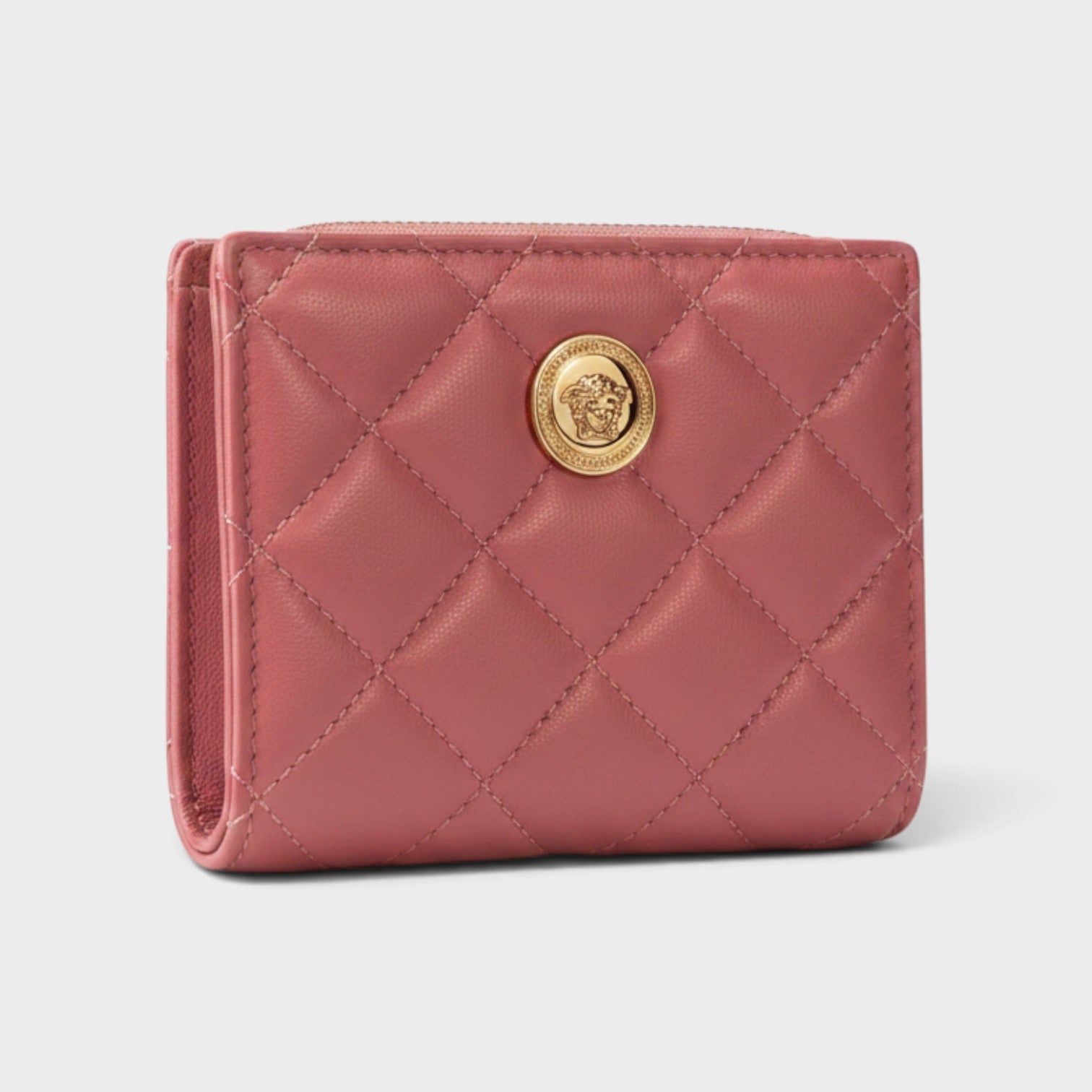 Supplied Fashion pink quilted leather wallet featuring a gold Medusa head emblem and compact bi-fold design.
