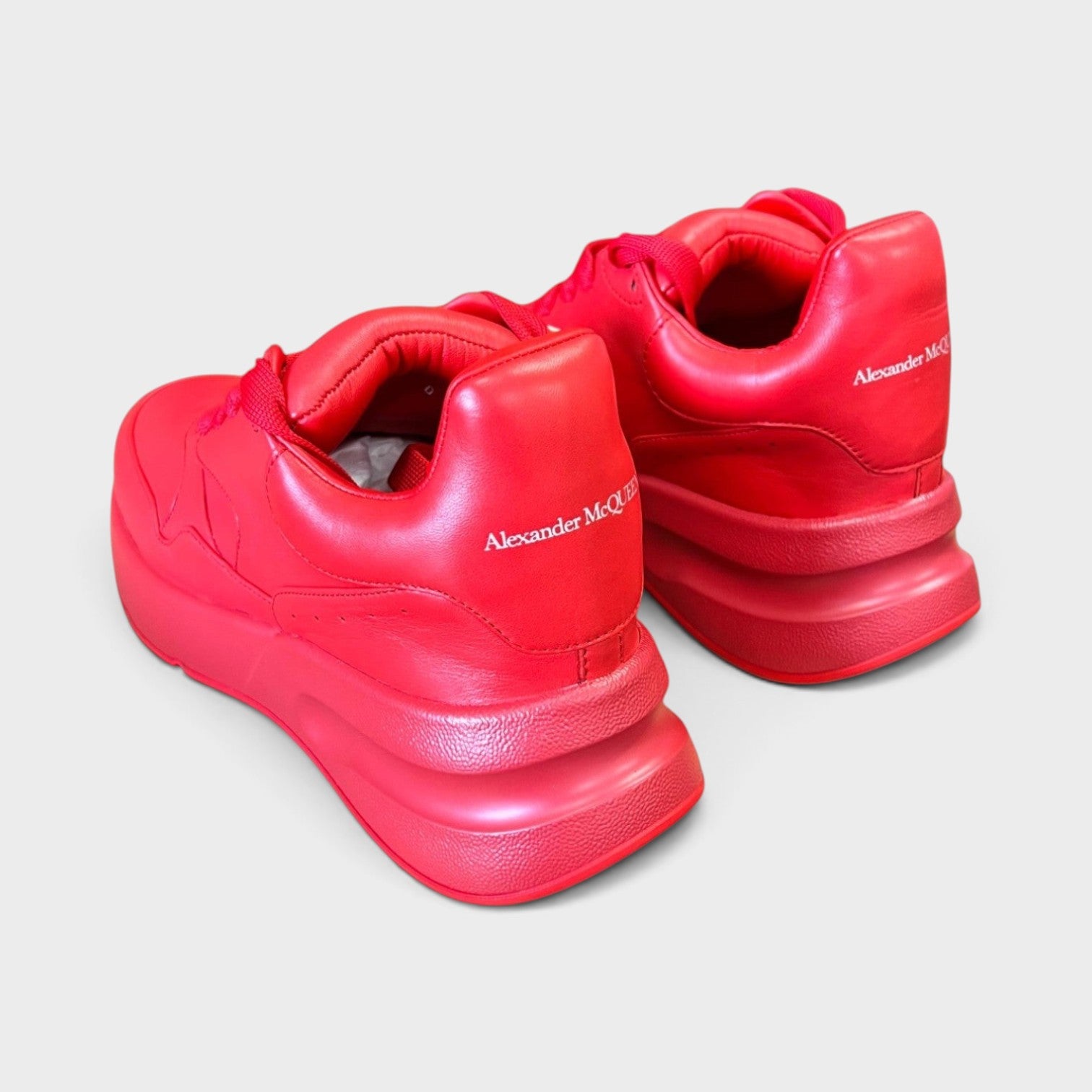 Supplied Fashion Alexander McQueen red oversized runner sneakers with signature exaggerated soles and heel branding