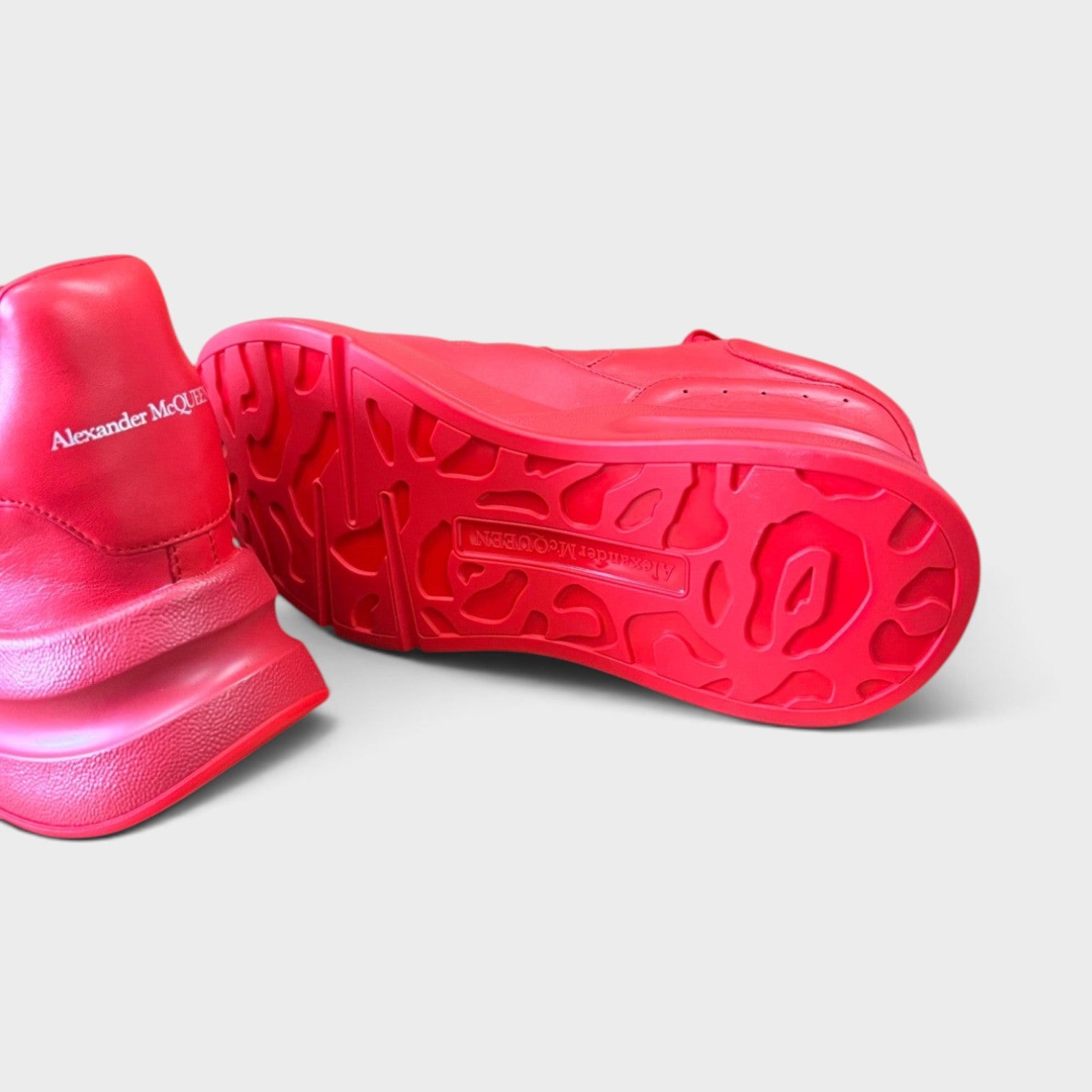 Supplied Fashion Alexander McQueen red oversized runner sneakers showing the textured sole and heel branding