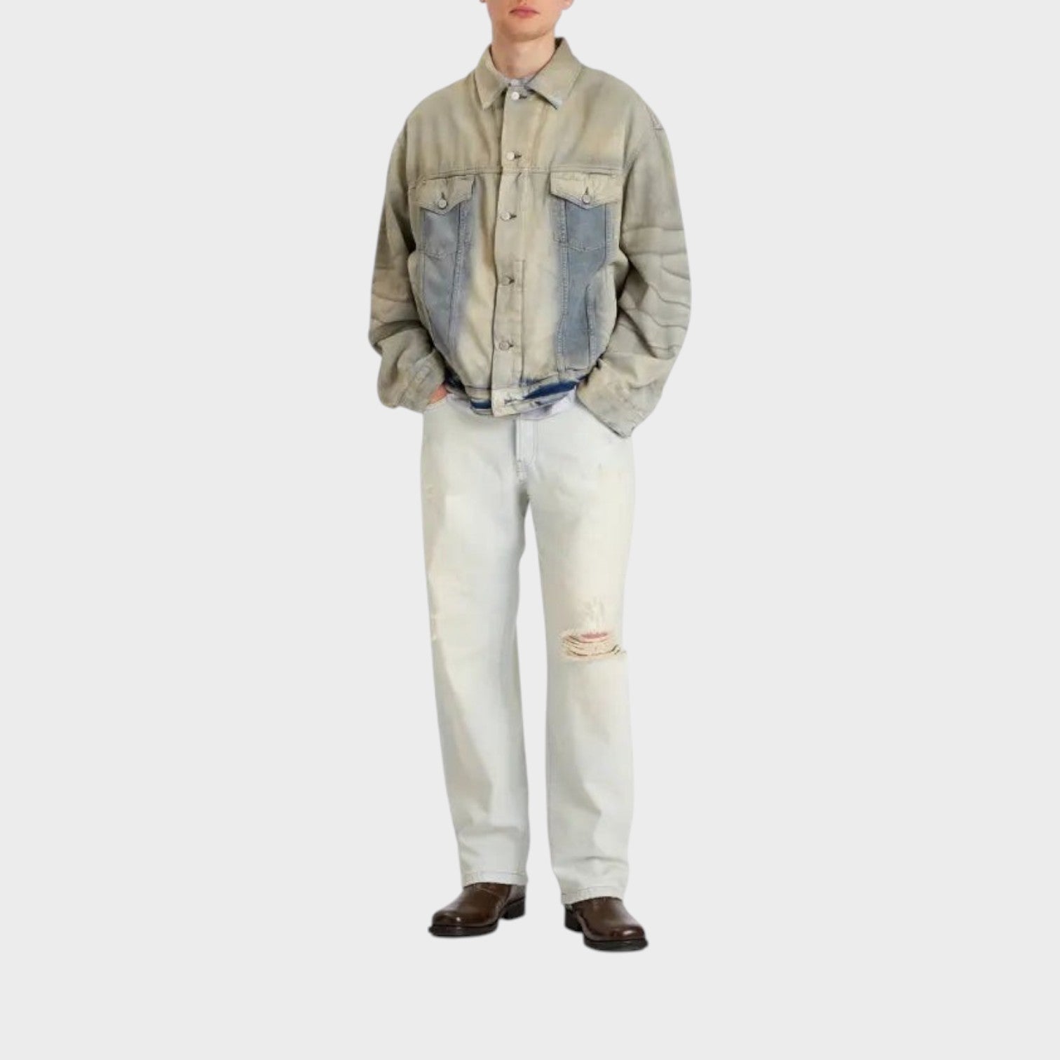 Supplied Fashion Robert U Carver light blue denim trucker jacket worn by a model with distressed jeans