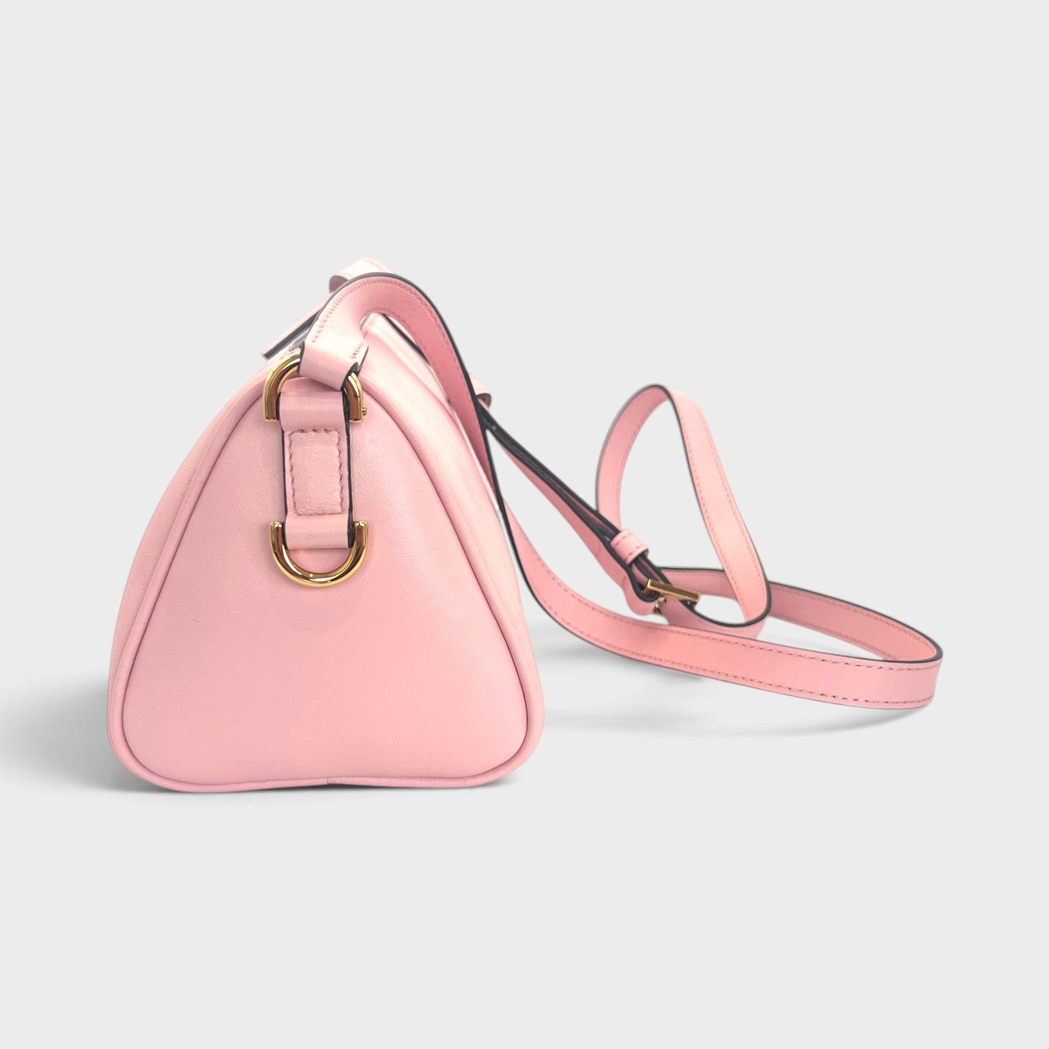 Supplied Fashion rose pink Versace Medusa crossbody bag with gold hardware and adjustable strap, side view