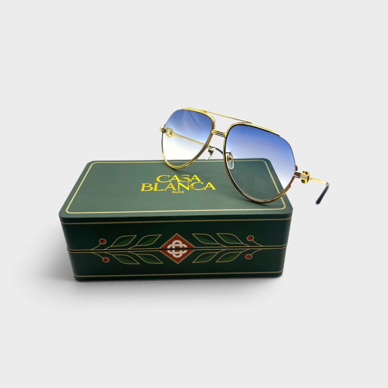 Supplied Fashion stainless steel aviator sunglasses with gold, silver, and midnight blue gradient lenses on a green box.