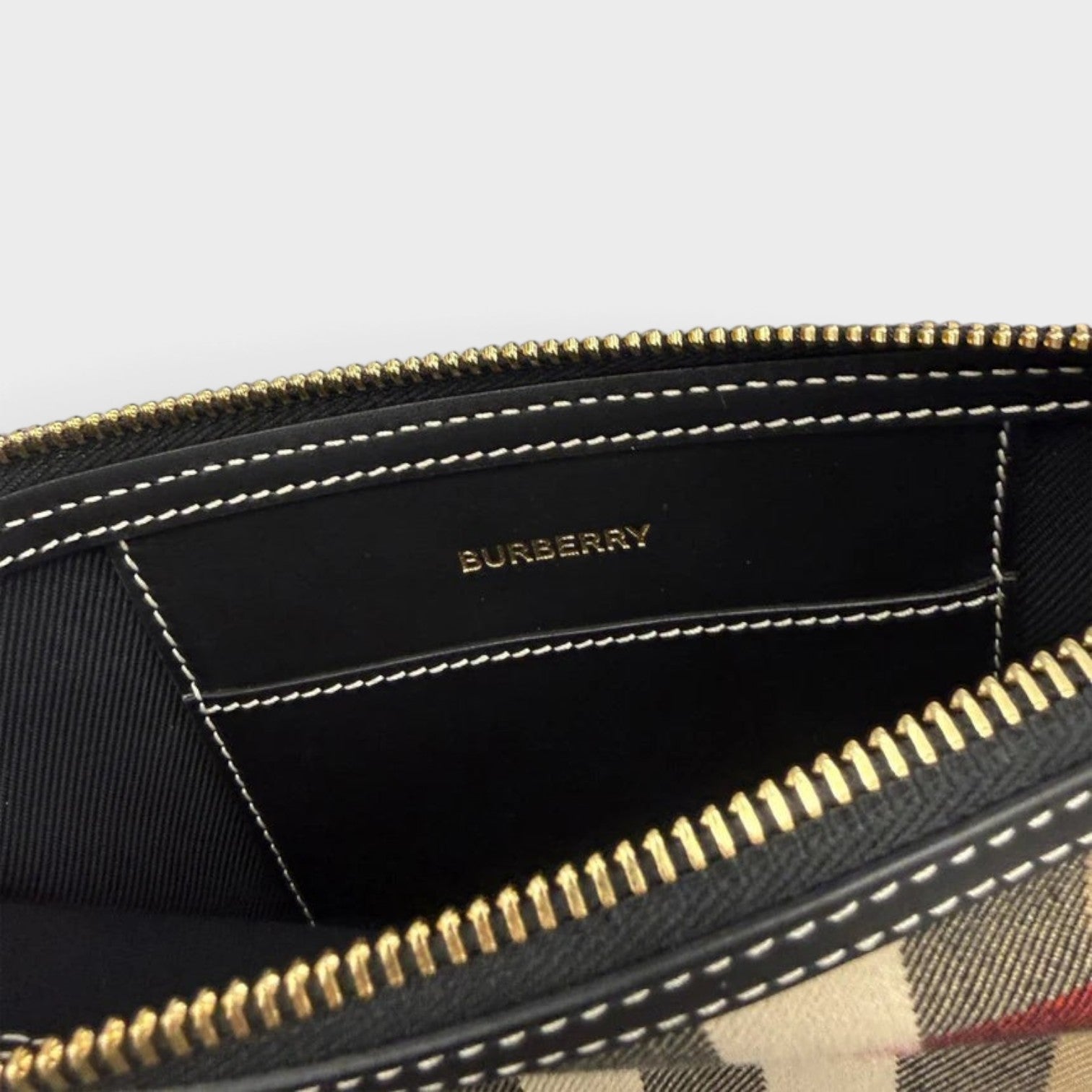 Supplied Fashion Peyton check wristlet in taupe brown with gold zipper and interior brand logo detail