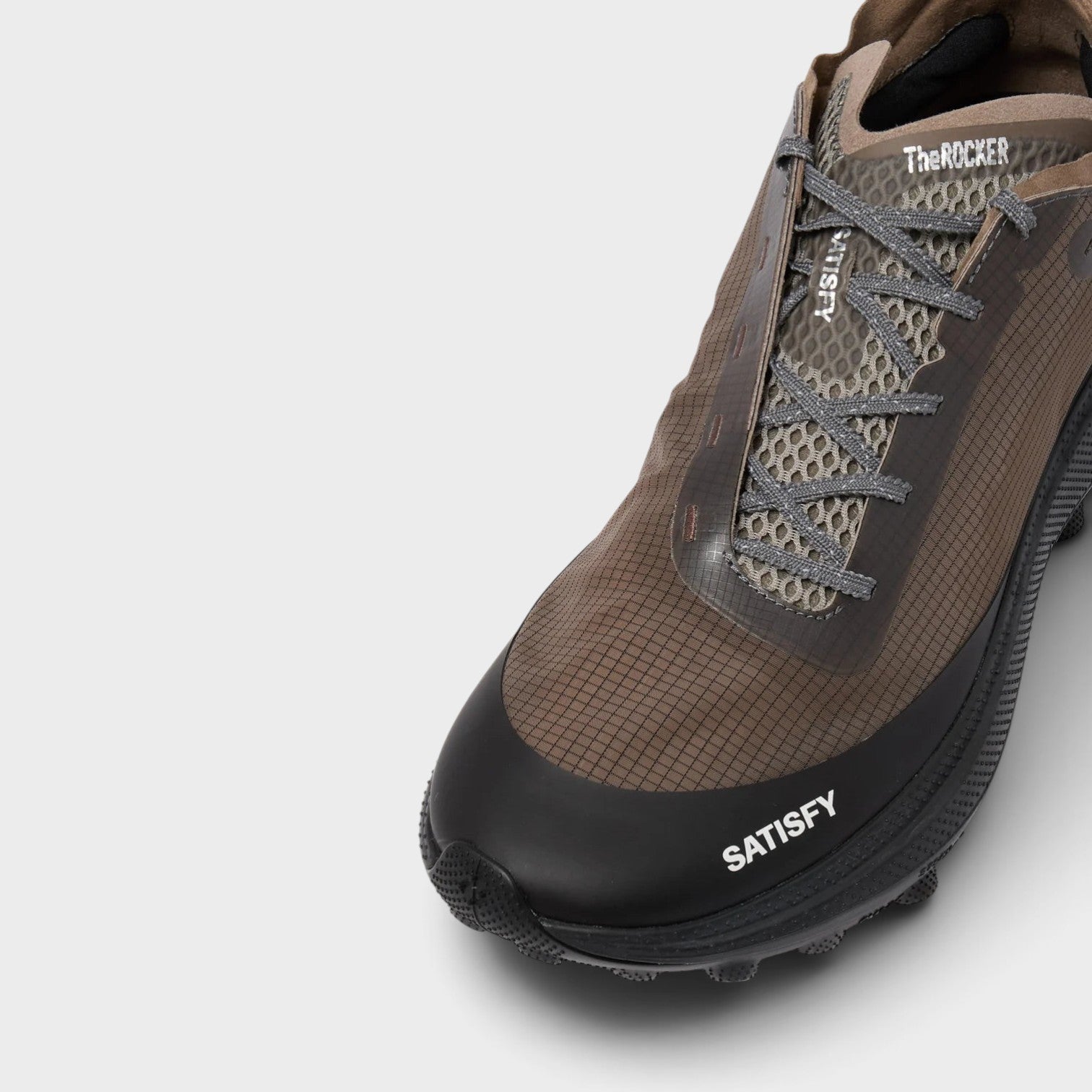 Supplied Fashion The Rocker sneakers in brown with a grid-patterned upper, black toe cap, and grey lace-up closure.
