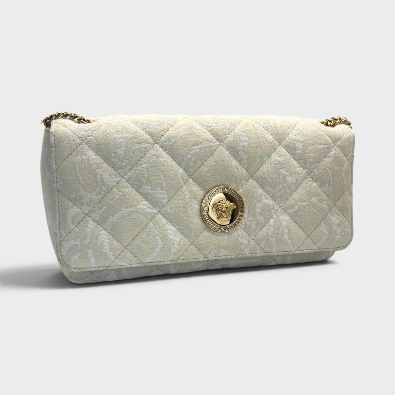 Supplied Fashion Versace Medusa Head medium shoulder bag in beige quilted fabric with gold-tone hardware.