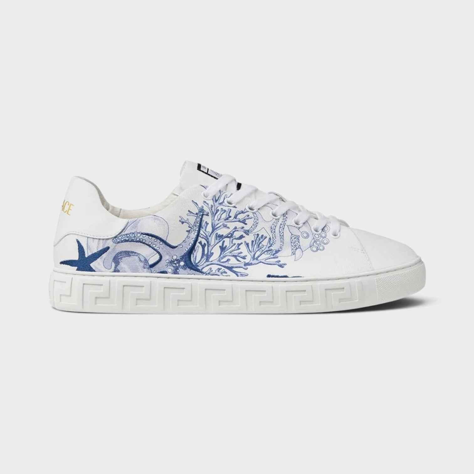 Supplied Fashion Versace Coral Theatre Greca sneakers in white leather with blue marine-themed print and side motif.