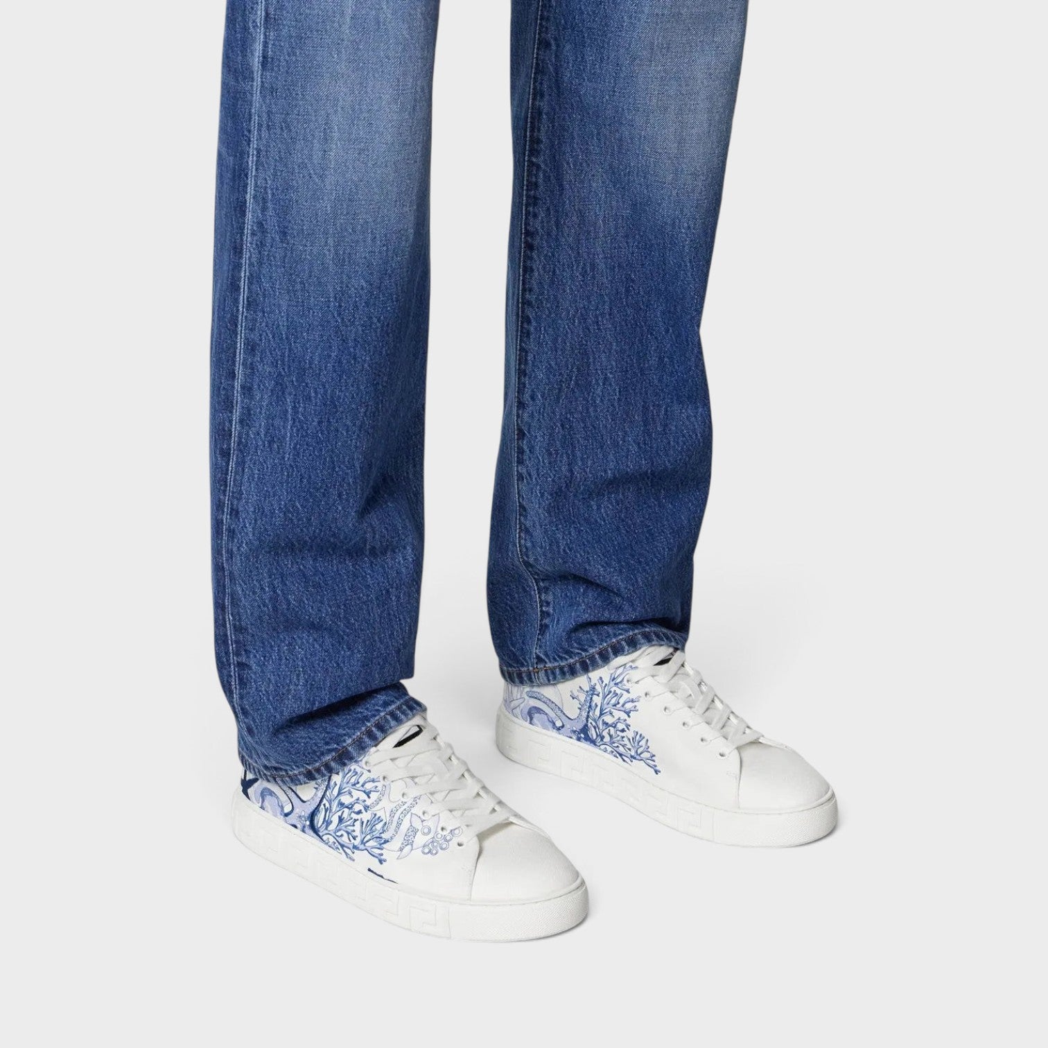 Supplied Fashion Versace Coral Theatre Greca sneakers in white leather with blue coral print and embossed side soles.
