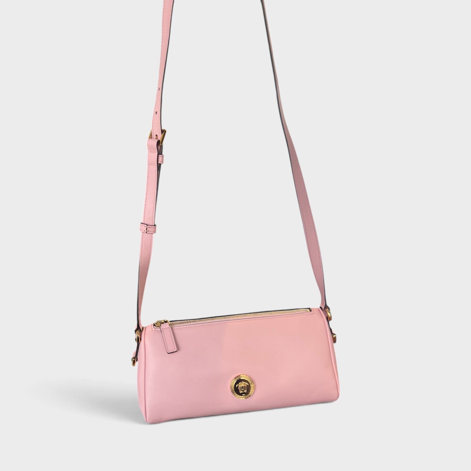 Supplied Fashion Versace Medusa crossbody bag in rose pink leather with gold hardware and adjustable shoulder strap.