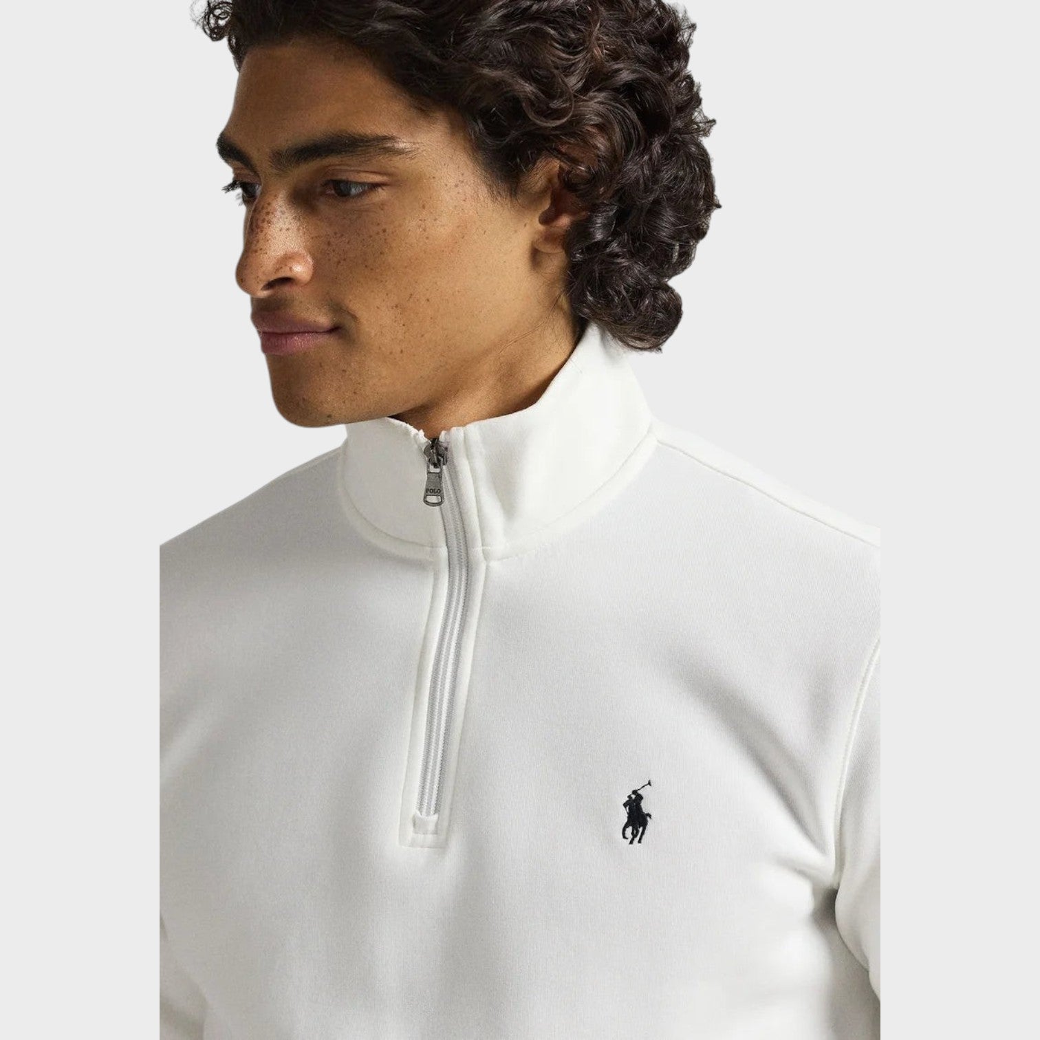 Supplied Fashion white knit quarter-zip pullover with a small black embroidered logo on the chest worn by a man