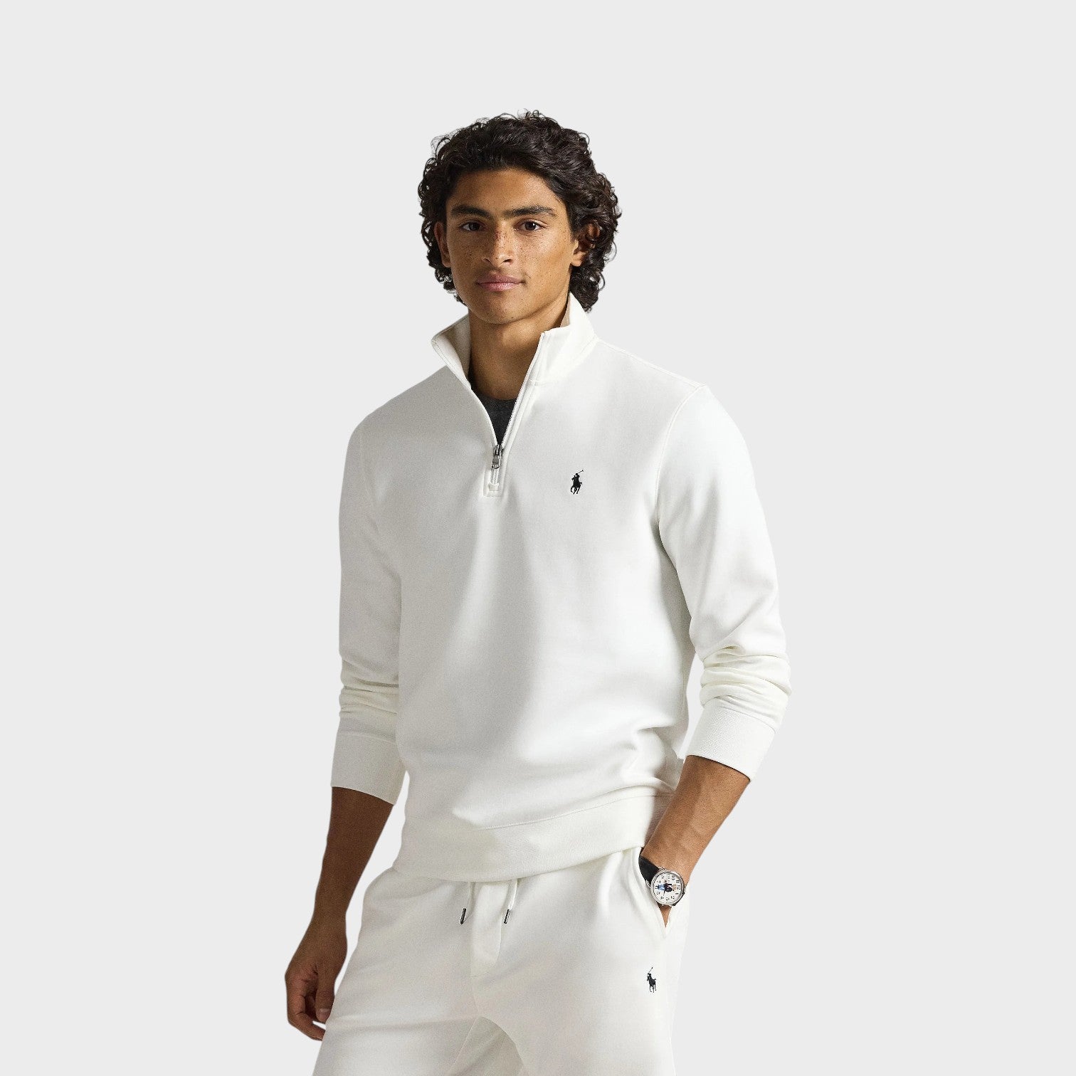 Supplied Fashion white knit quarter-zip pullover sweatshirt worn by a man with ribbed cuffs and logo embroidery.