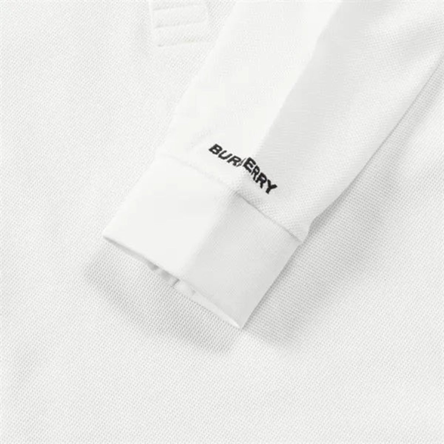 Supplied Fashion white long sleeve polo shirt featuring a textured cotton fabric and Burberry logo on the cuff