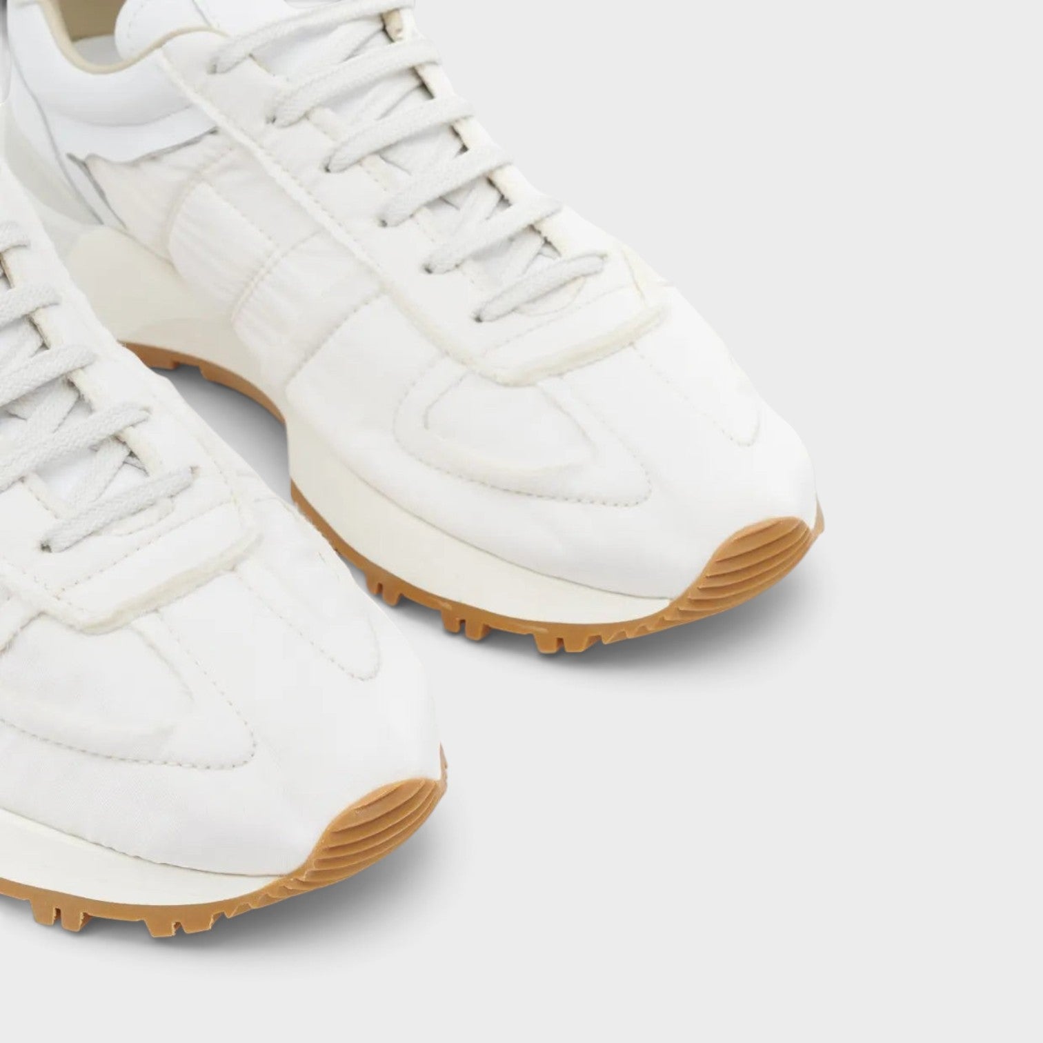 Supplied Fashion white Maison Margiela 50-50 sneakers with leather upper, tonal stitching, and gum rubber split sole.