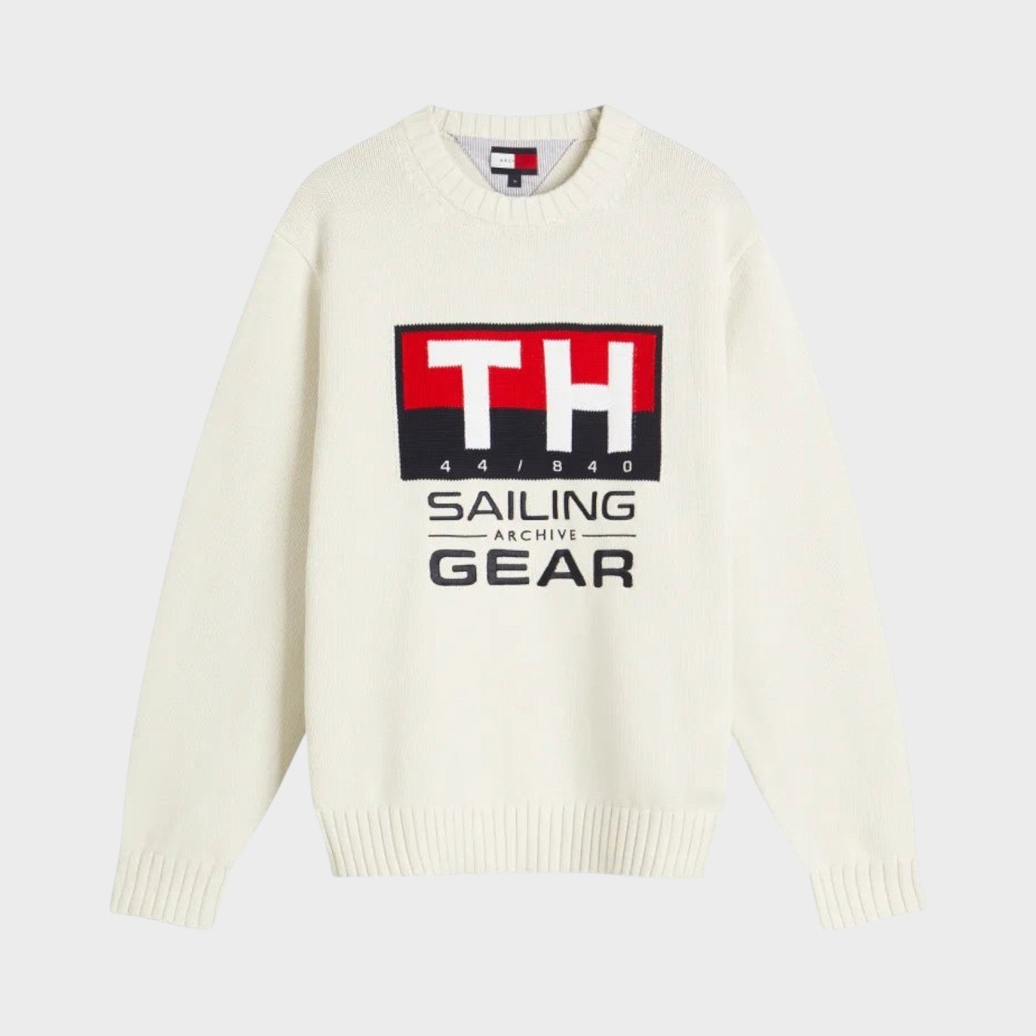 Supplied Fashion Tommy Hilfiger white crewneck knit sweater featuring a nautical sailing gear graphic logo on the chest
