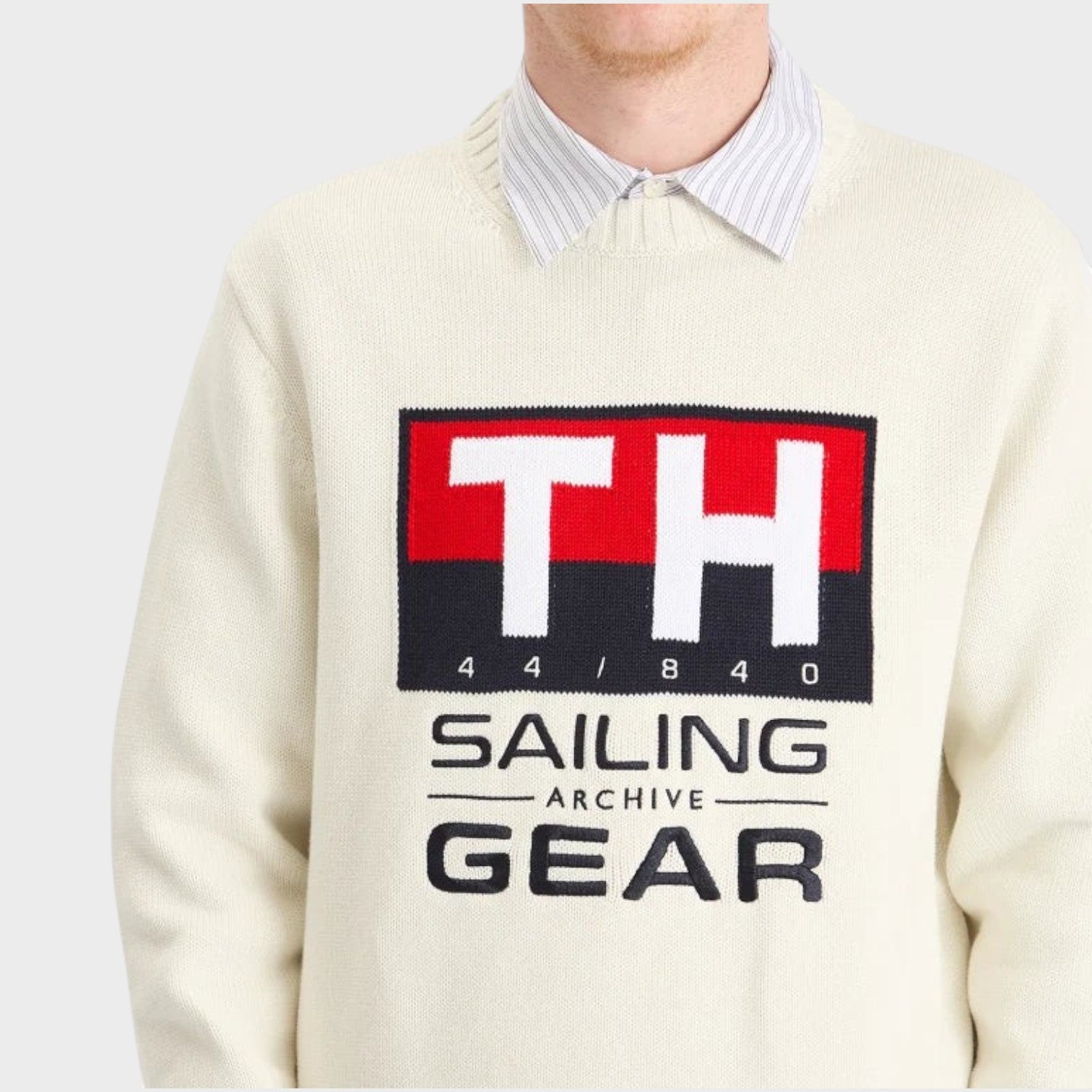 Supplied Fashion white crewneck knit sweater featuring a Tommy Hilfiger Gi Sailing graphic logo on the chest