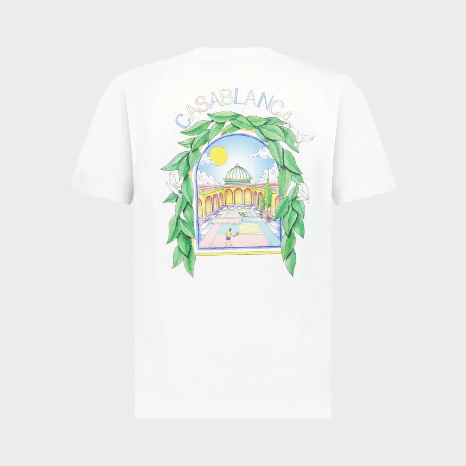 Supplied Fashion white short sleeve t-shirt featuring a back graphic of a tennis court scene with green foliage.