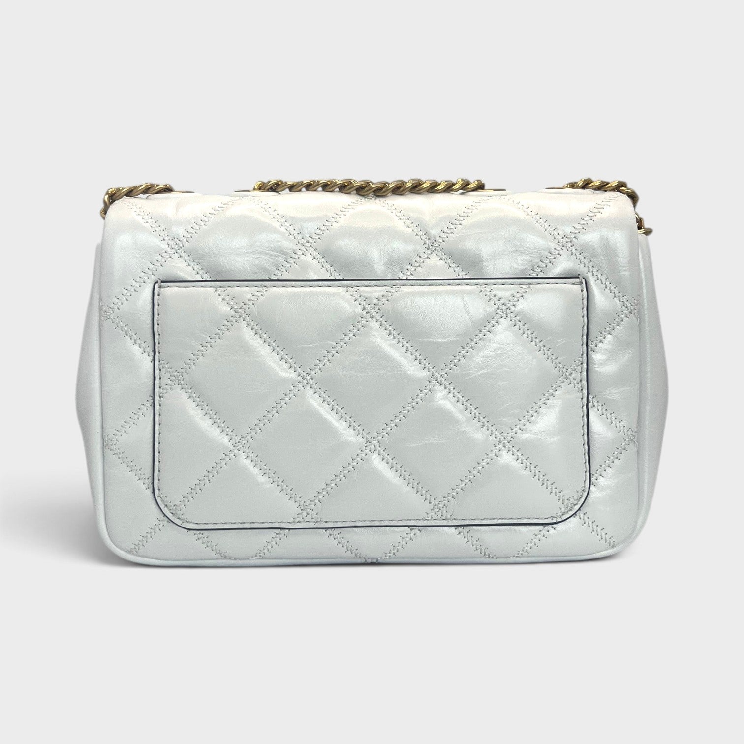 Supplied Fashion Willa small shoulder bag in white glazed quilted leather with a gold chain strap, back view.